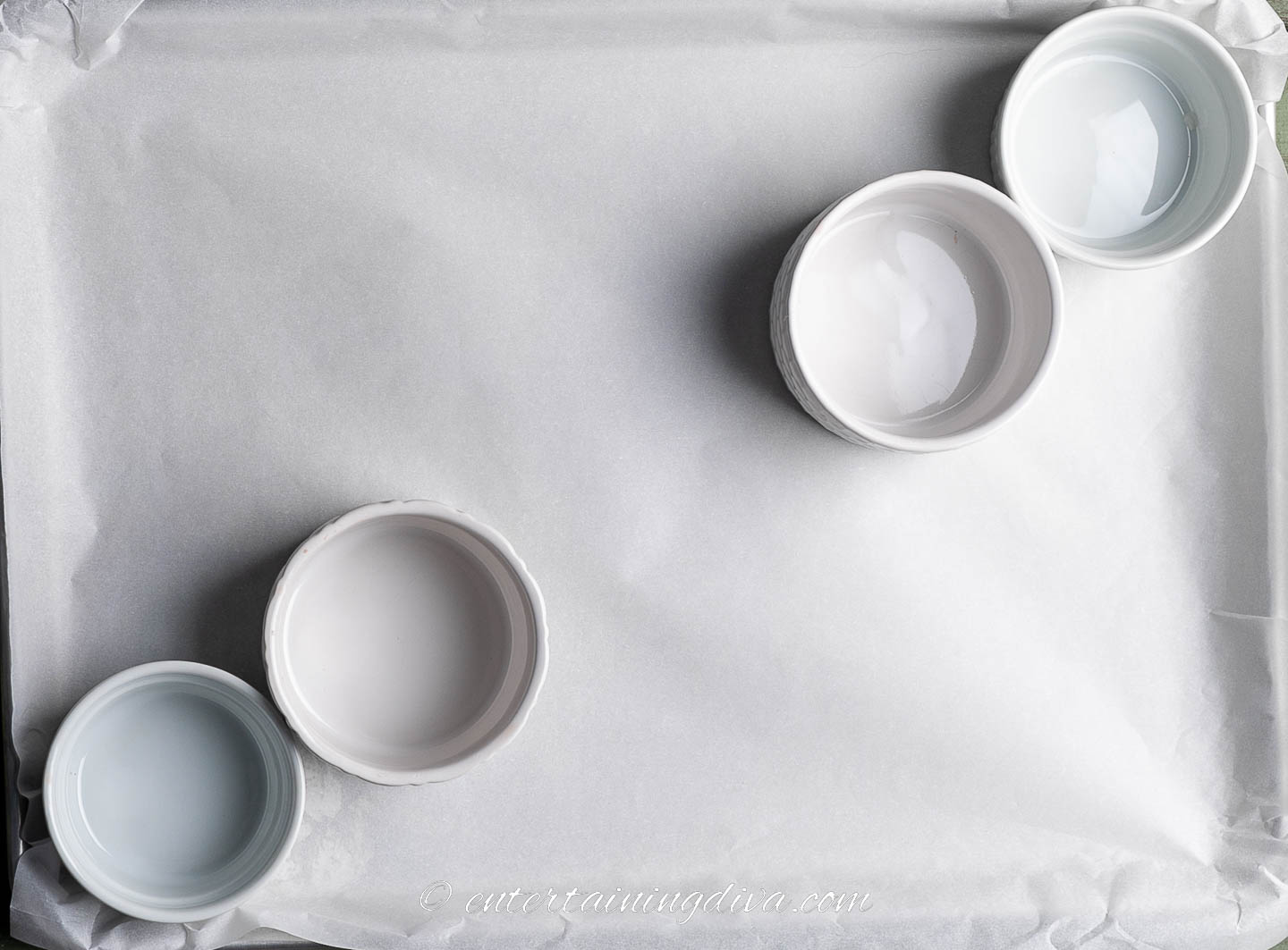 baking sheet with 4 small bowls arranged diagonally in the corners