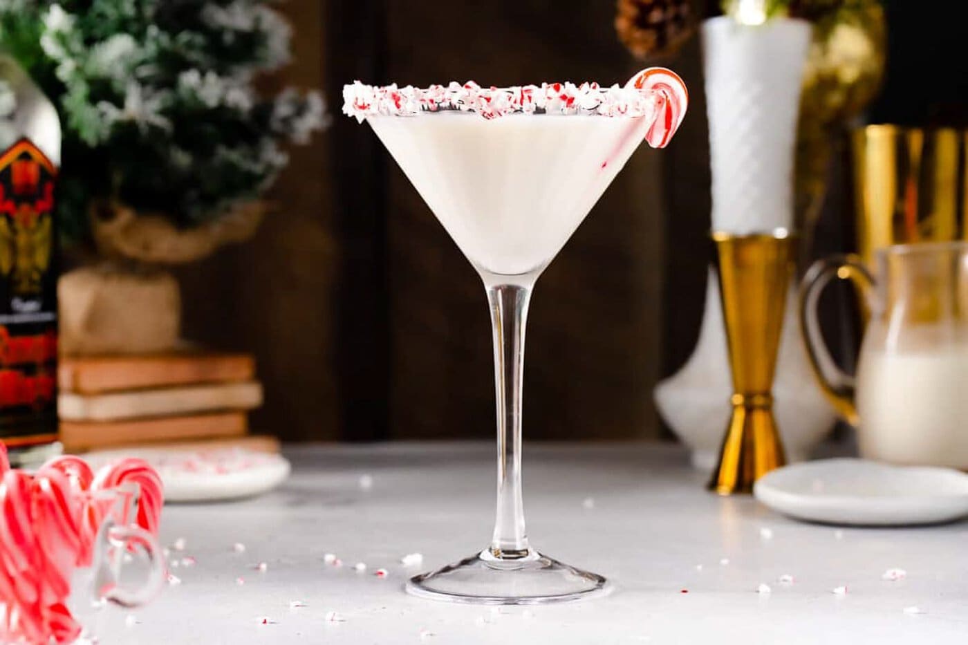 A martini with a candy cane garnish.