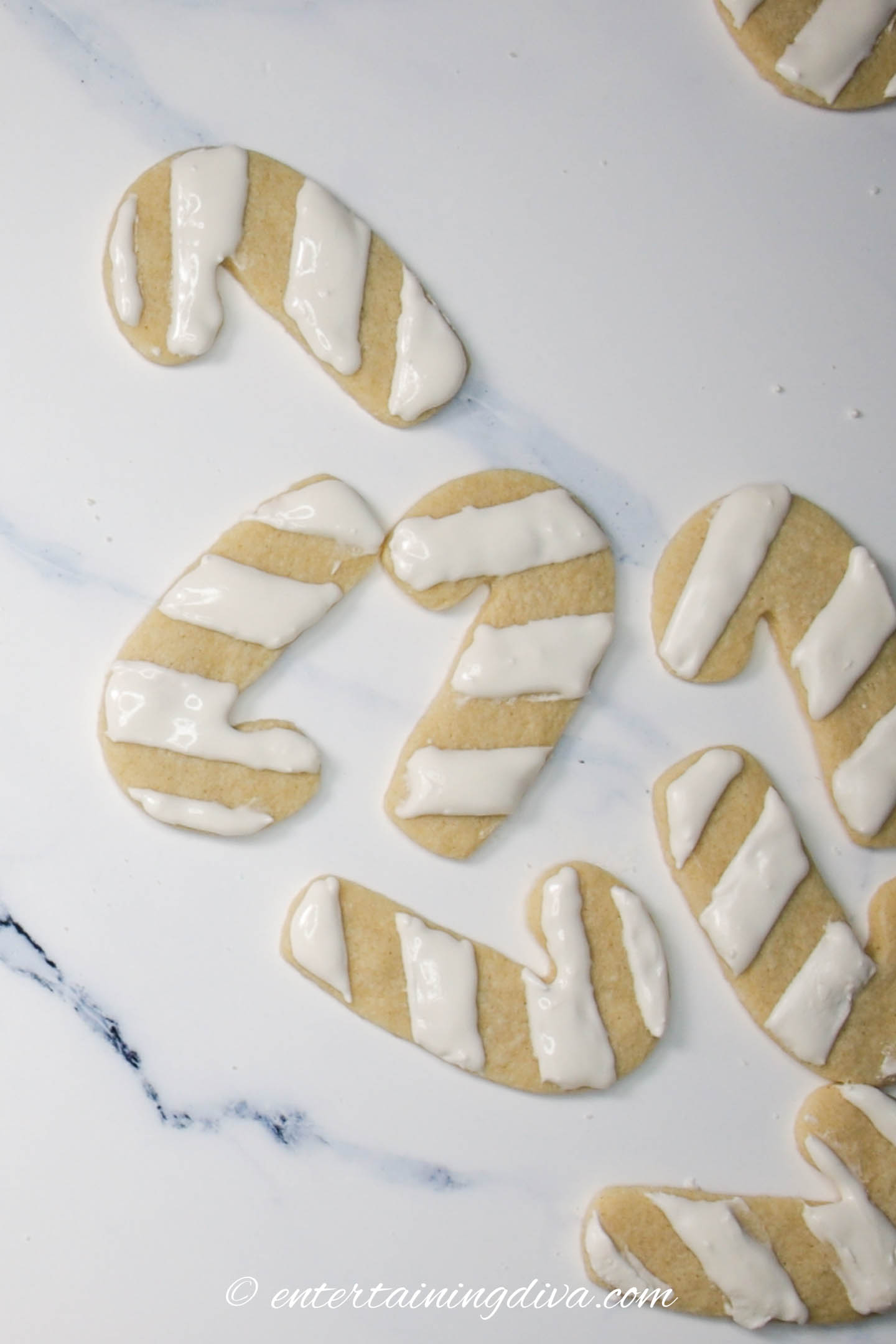 Candy cane sugar cookies with only the white stripes done