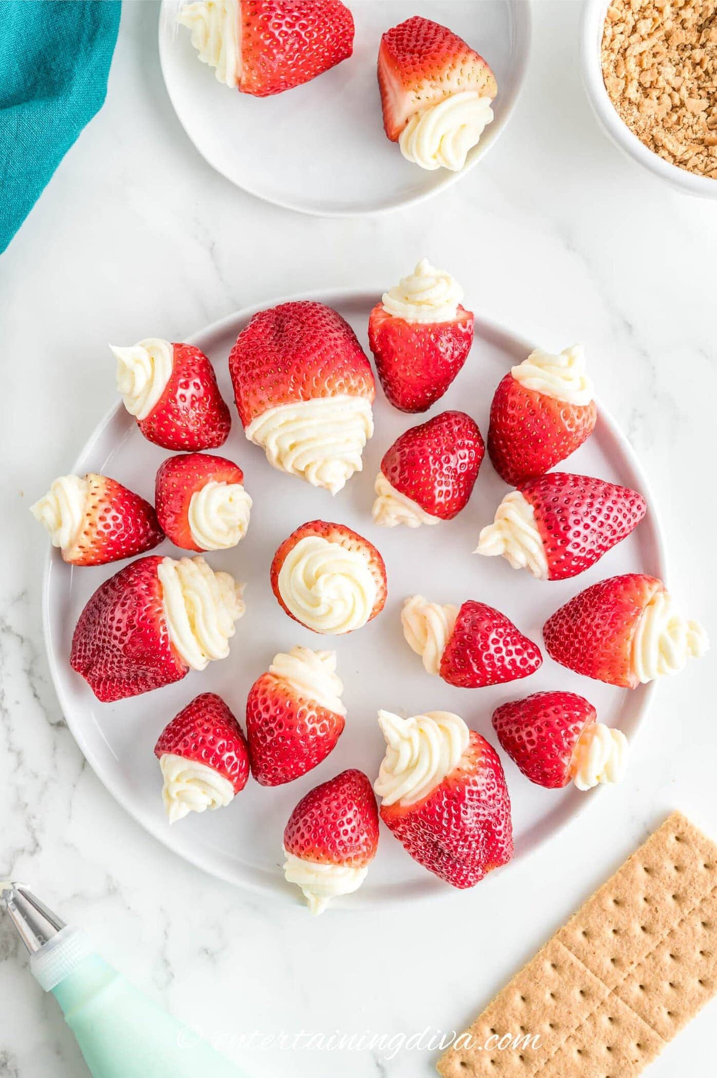 a plate of strawberries stuffed with no-bake cheesecake filling