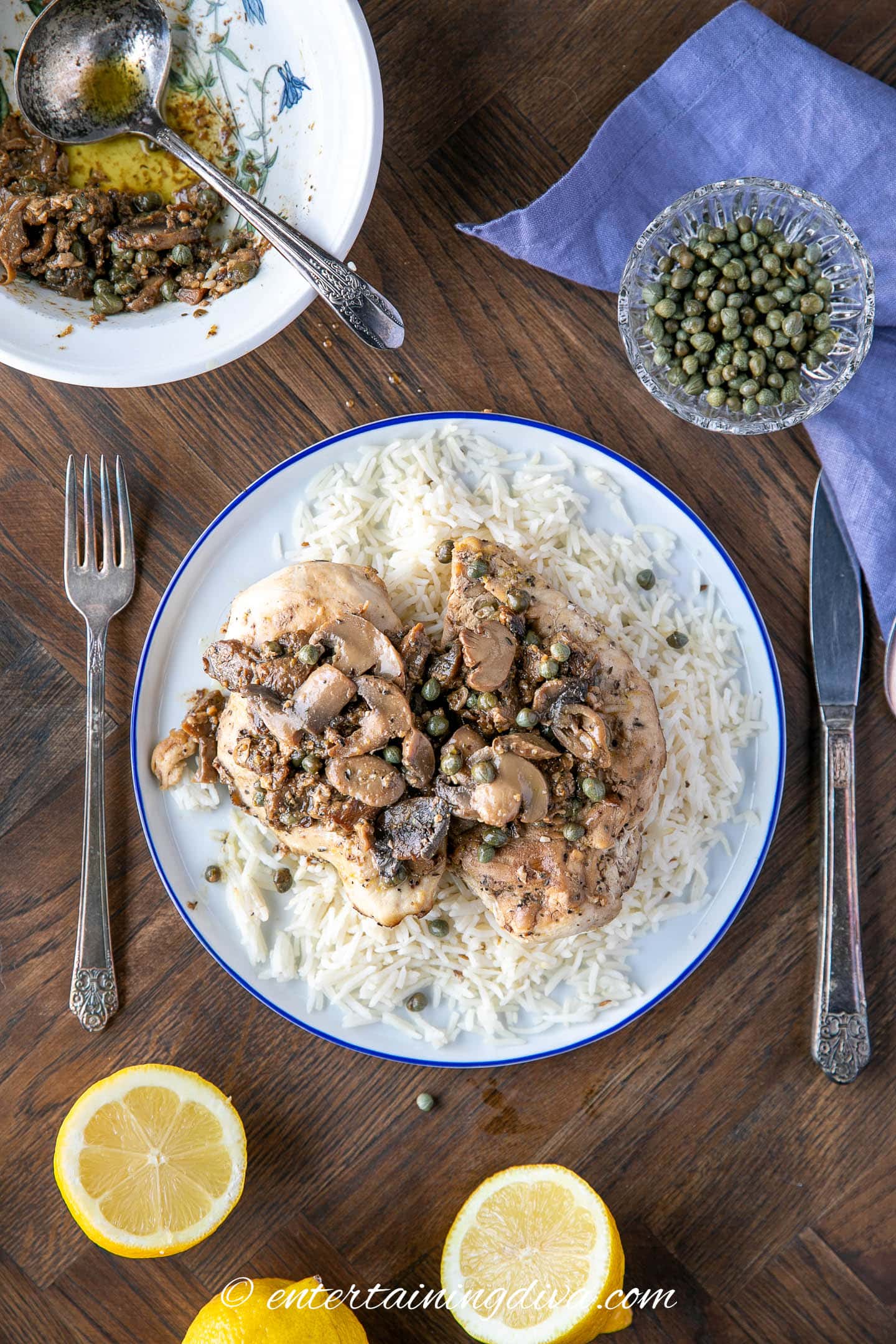 chicken piccata with mushrooms on a dinner table