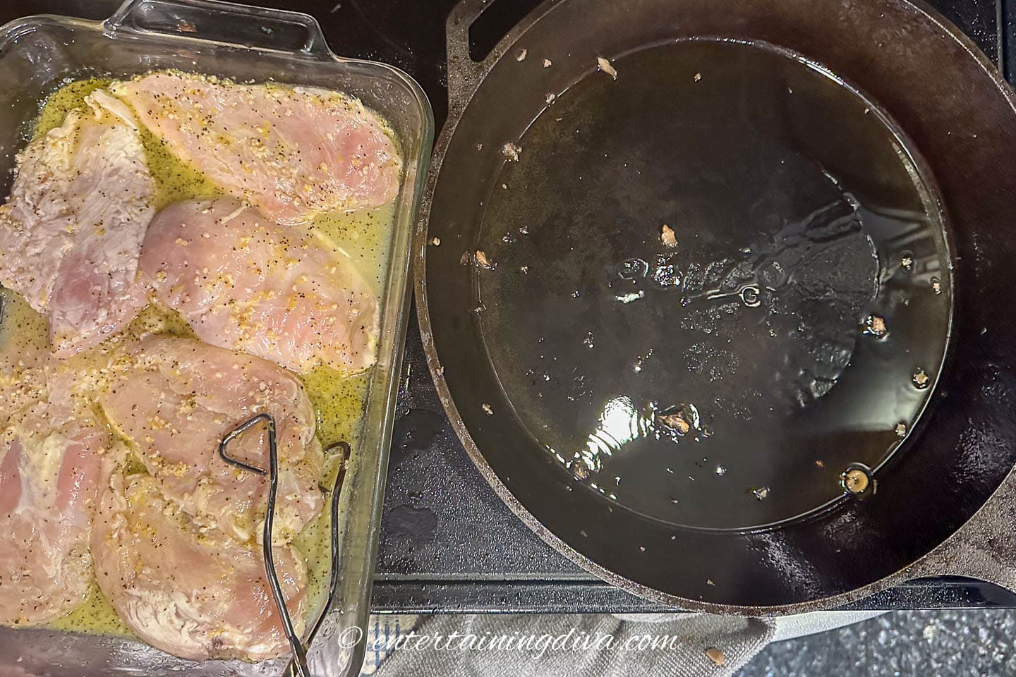 Marinated chicken breast being transferred to a cast iron pan
