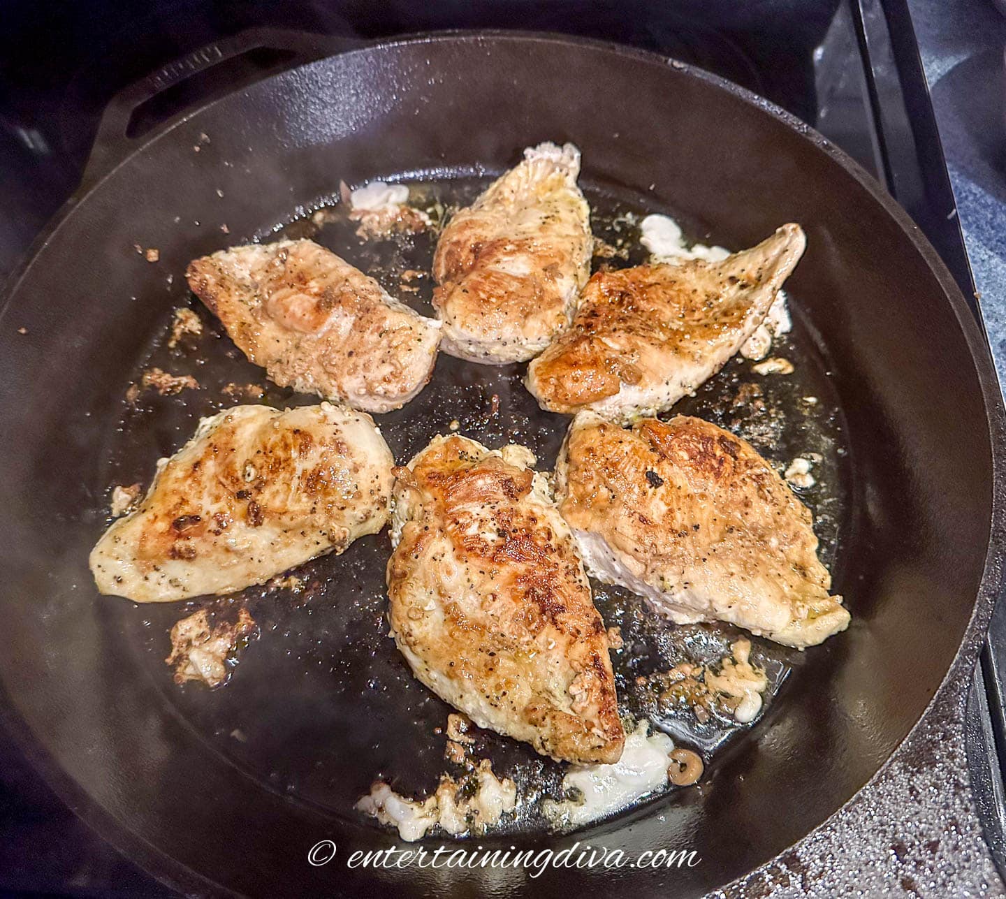 browned chicken breasts in a cast iron pan