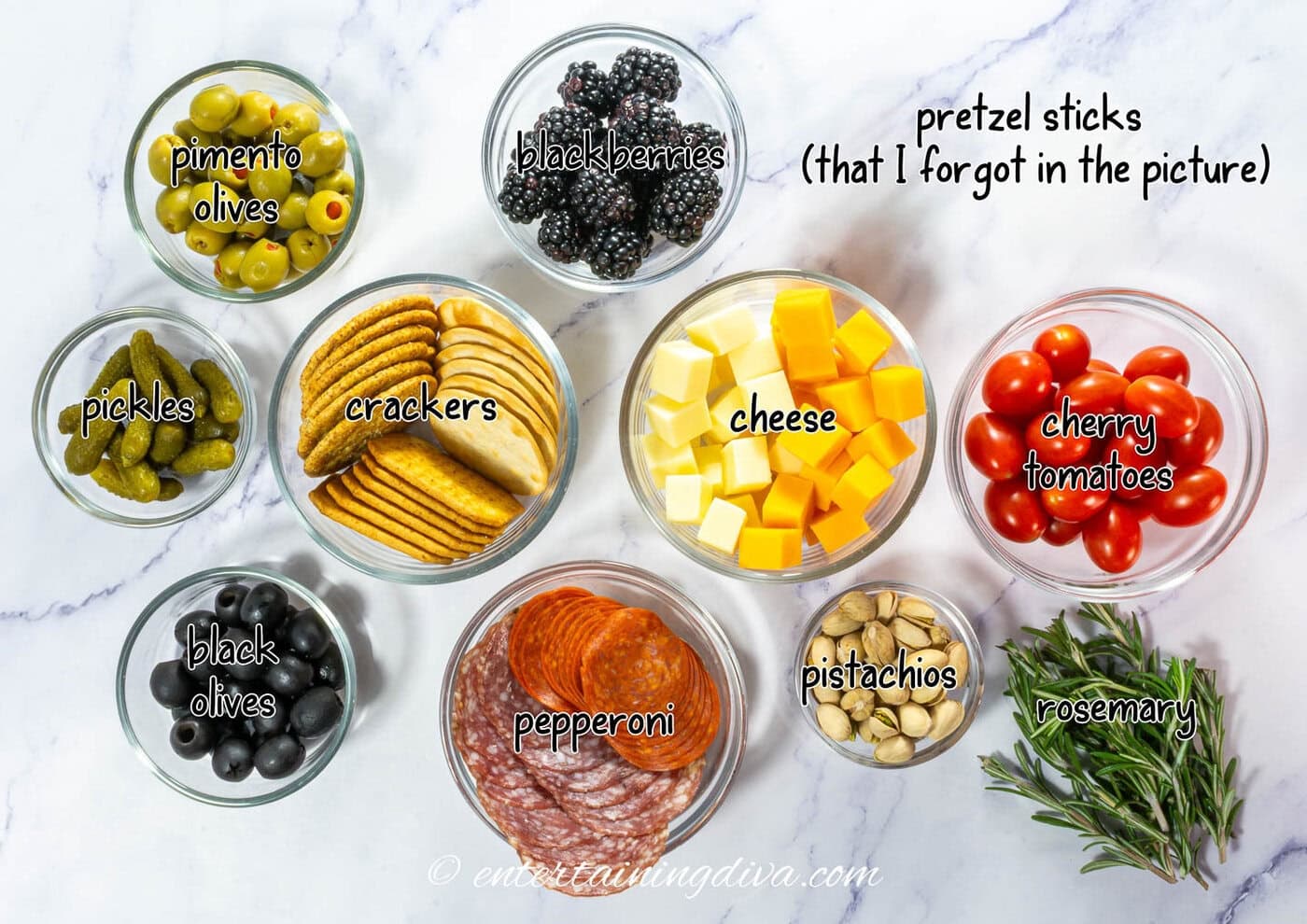Christmas tree charcuterie board ingredients - various meat, cheese and fruit with crackers
