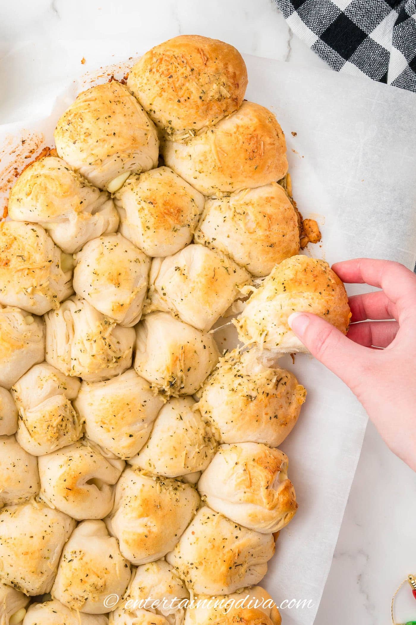 Christmas tree pull apart bread with a roll being pulled out