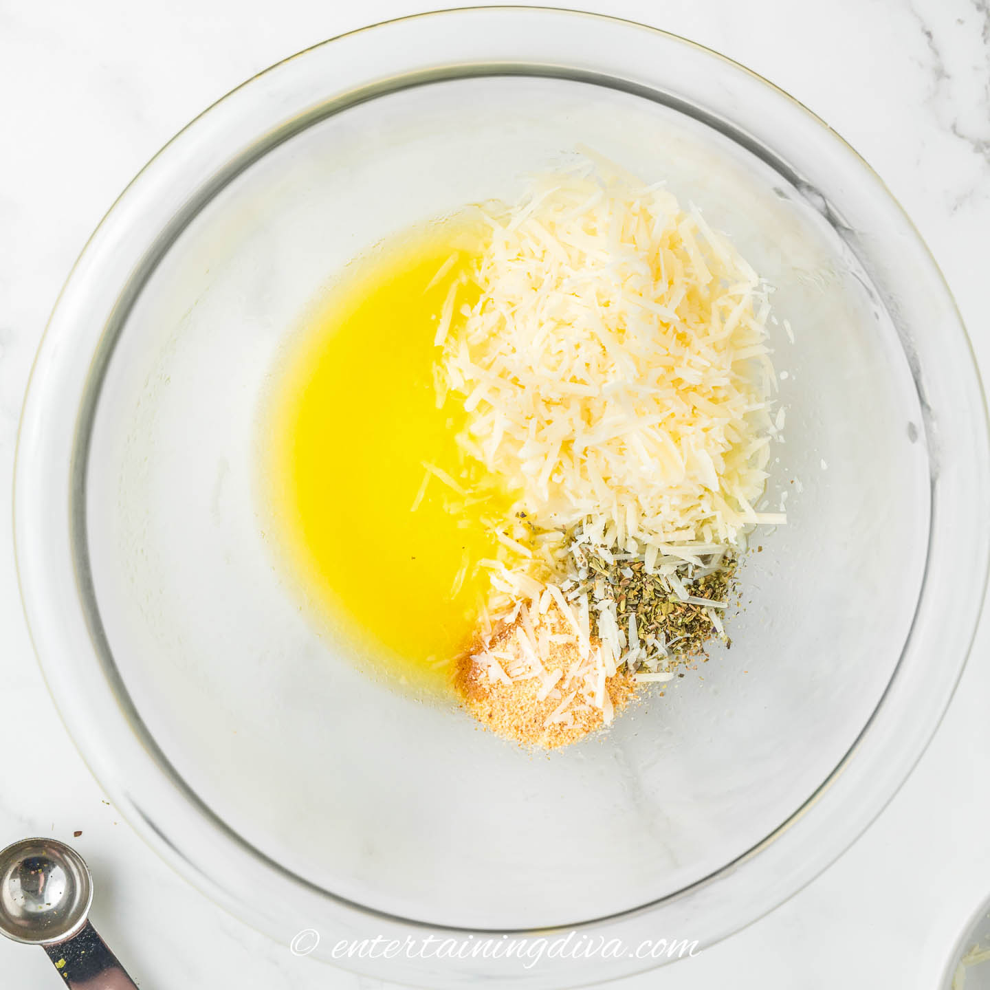 melted butter, shredded parmesan, garlic powder and Italian seasoning in a bowl