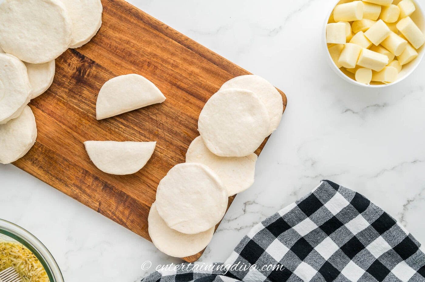 a biscuit cut in half on a cutting board