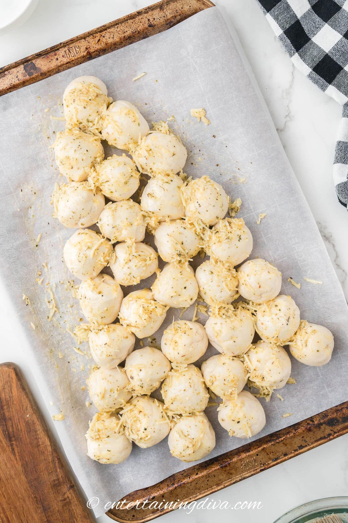 Christmas tree pull apart bread on a baking sheet before baking