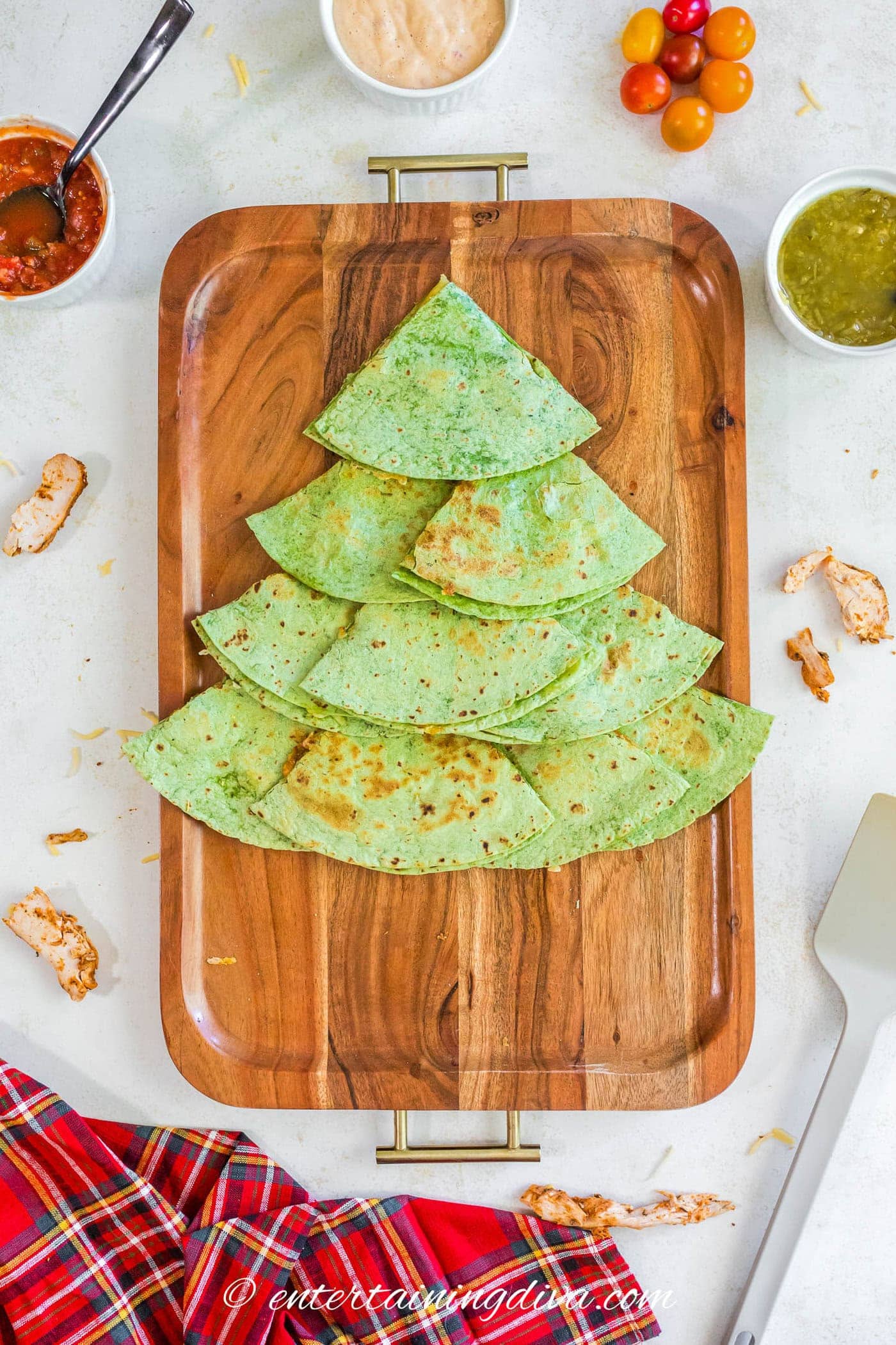 4 layers of quesadillas forming the shape of a Christmas tree