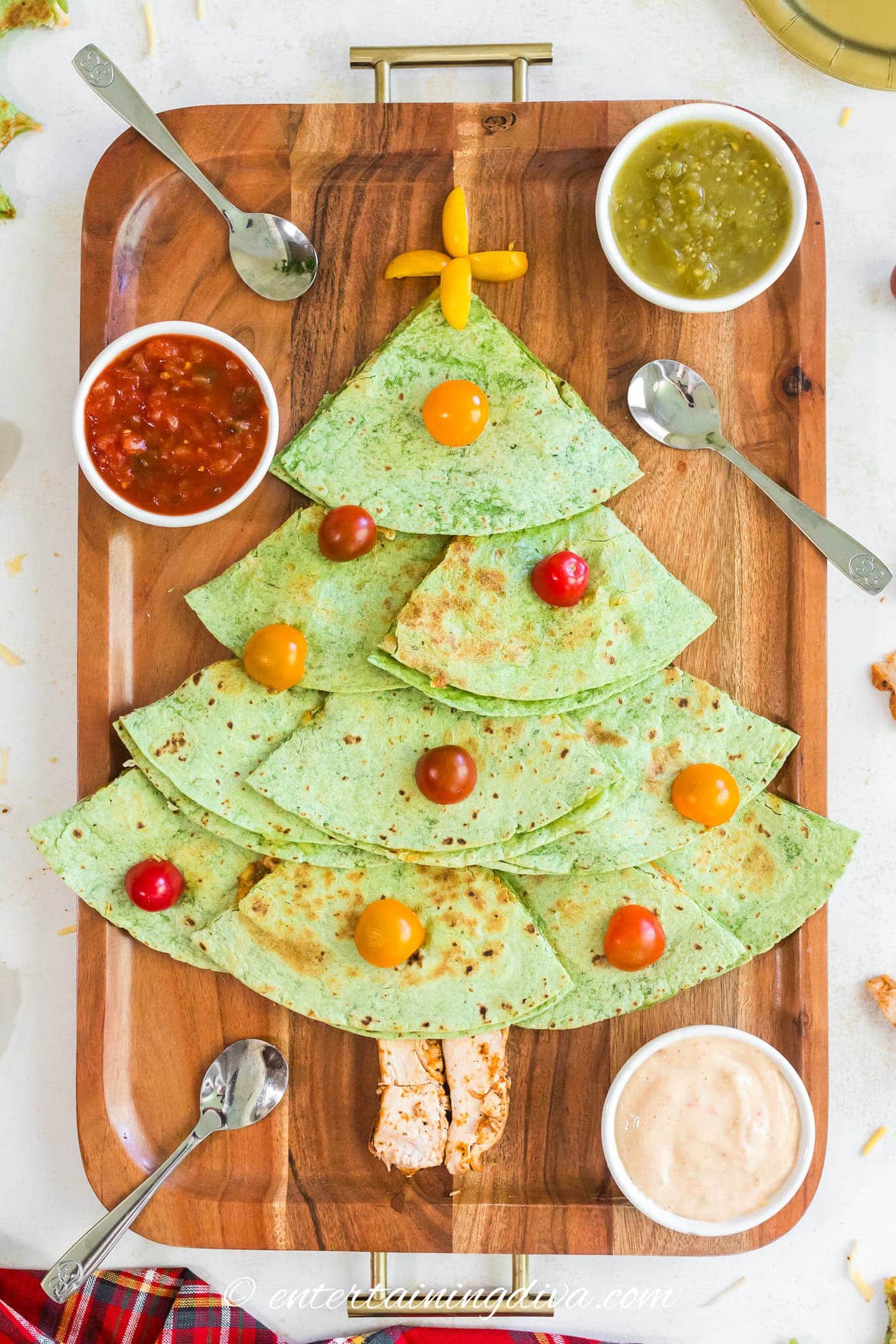 Christmas tree quesadillas on a serving tray with salsa and queso in serving bowls