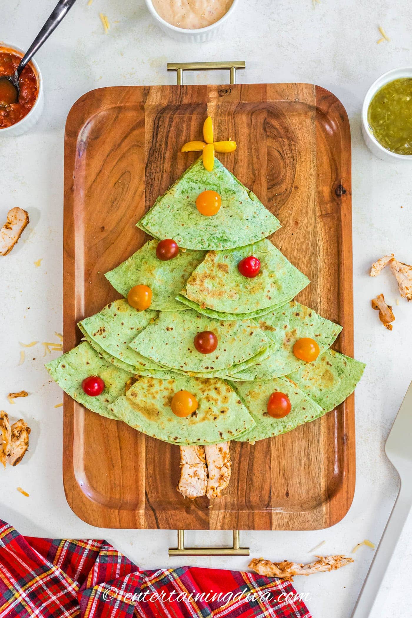Christmas tree quesadillas with cherry tomatoes used as ornaments