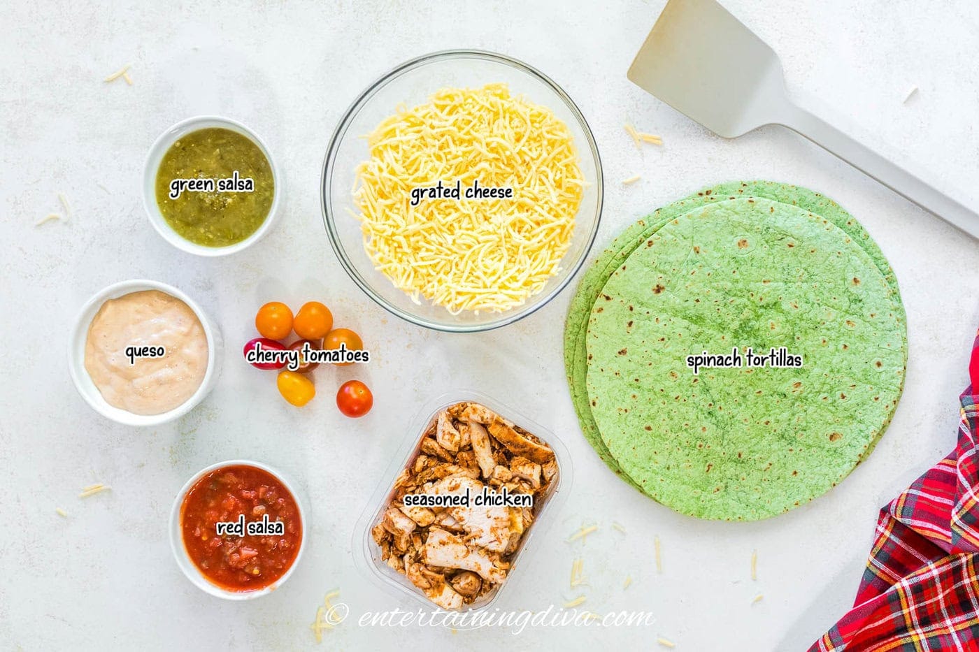 Christmas tree quesadillas ingredients - spinach tortillas, grated cheese, seasoned chicken, salsa, queso, green salsa, cherry tomatoes