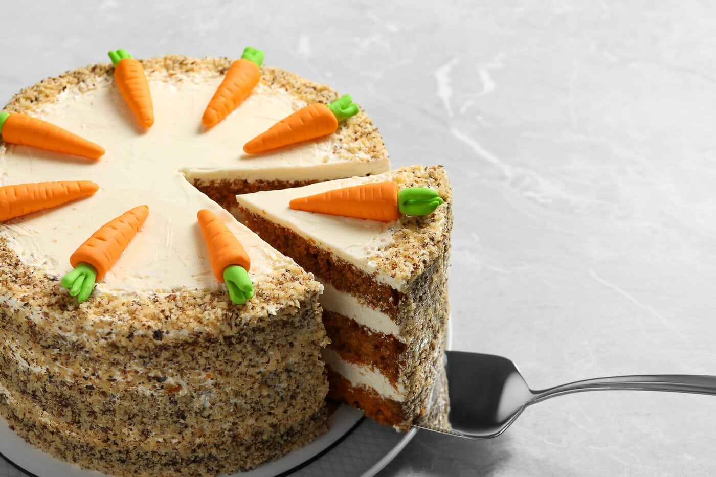 Carrot cake with piped frosting carrots on top
