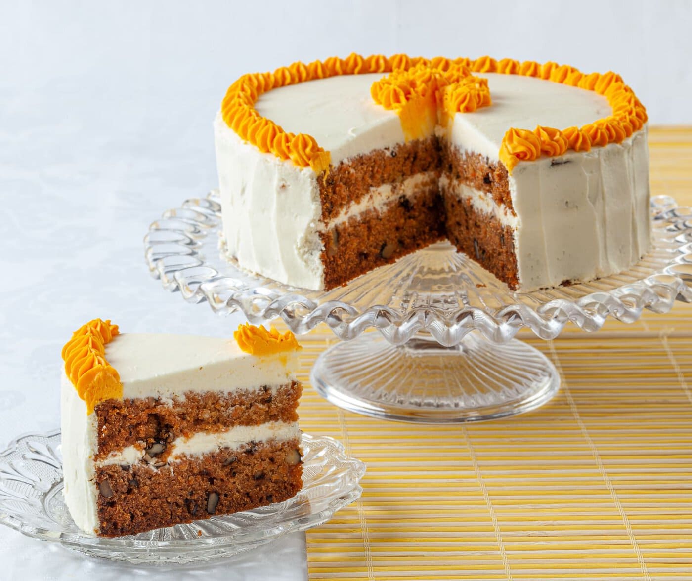 carrot cake with cream cheese icing and orange ruffle decorations