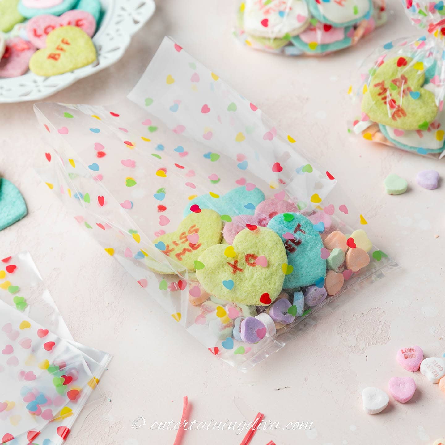 Conversation heart cookies with conversation heart candies in a Valentine treat bag