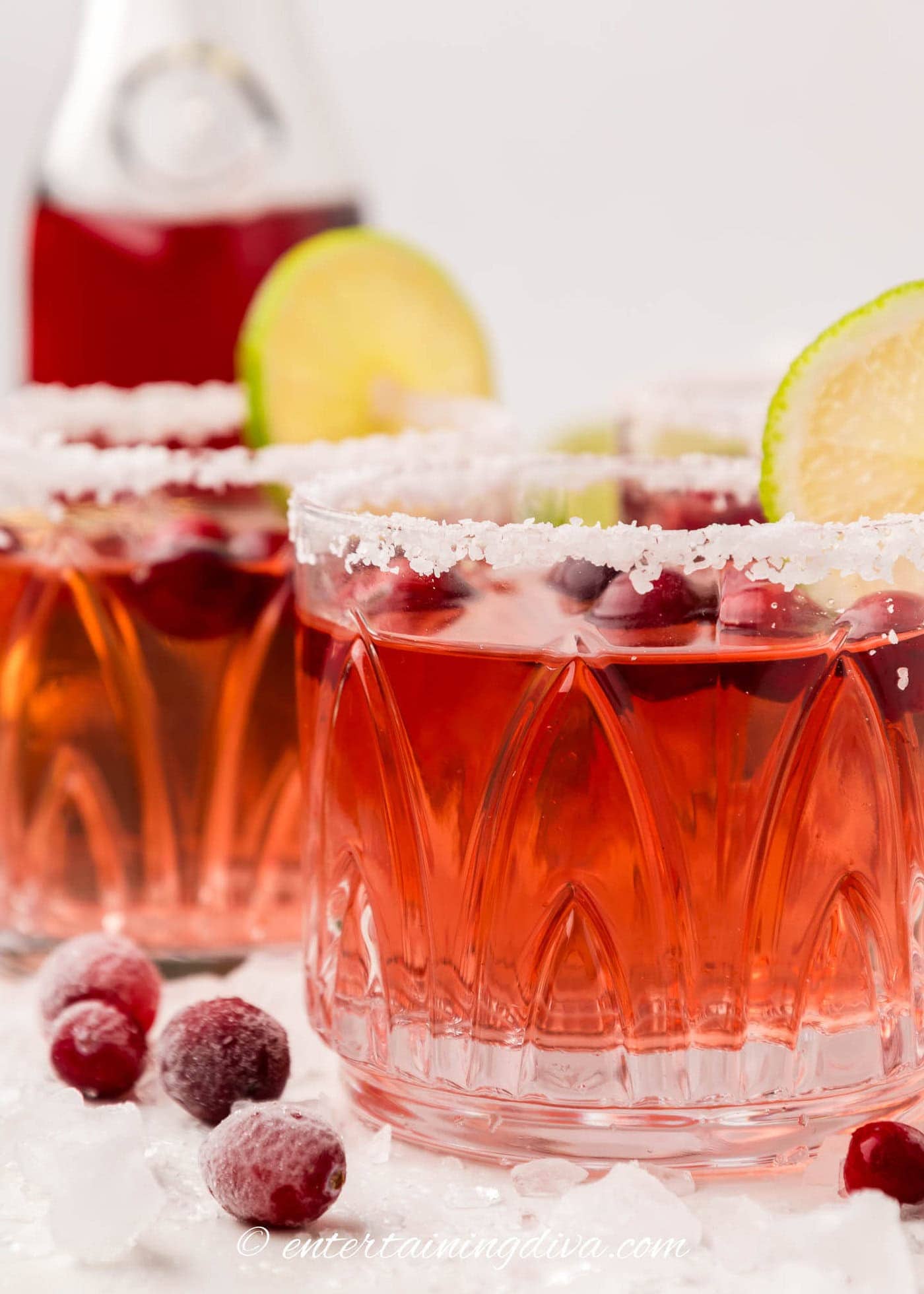 Side view of a cranberry margarita in a low-ball glass