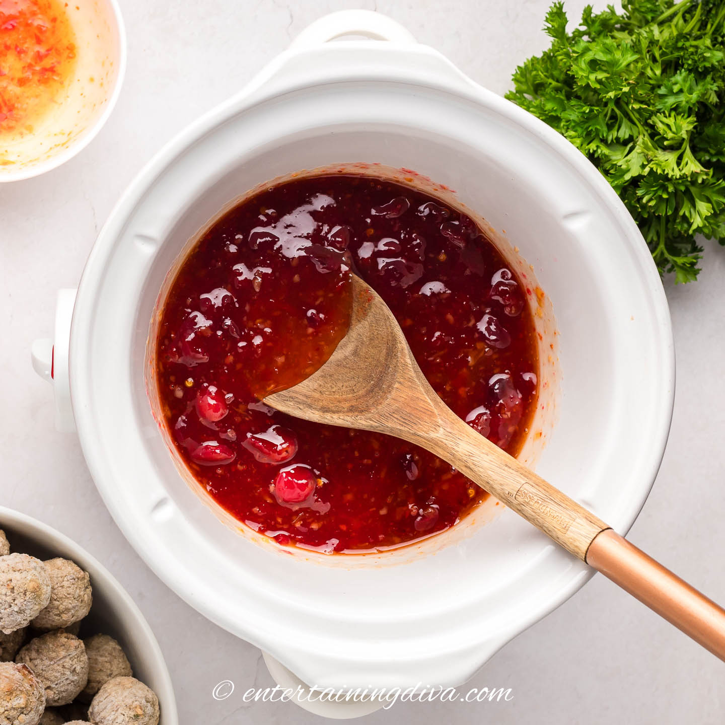 chili sauce and cranberry sauce mixed in a crock pot