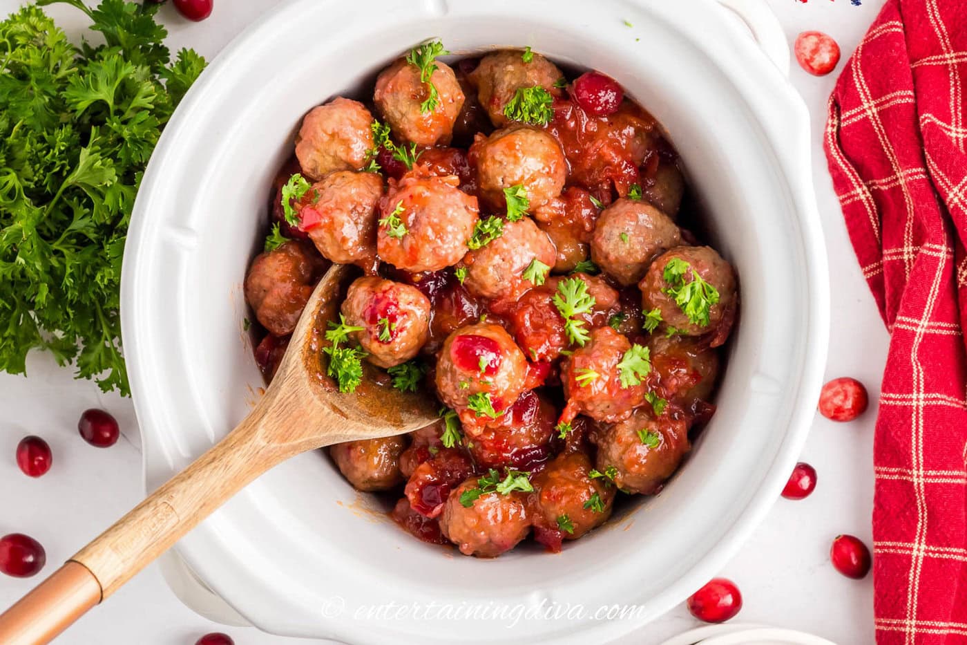 cranberry meatballs with chili sauce being served from a crockpot