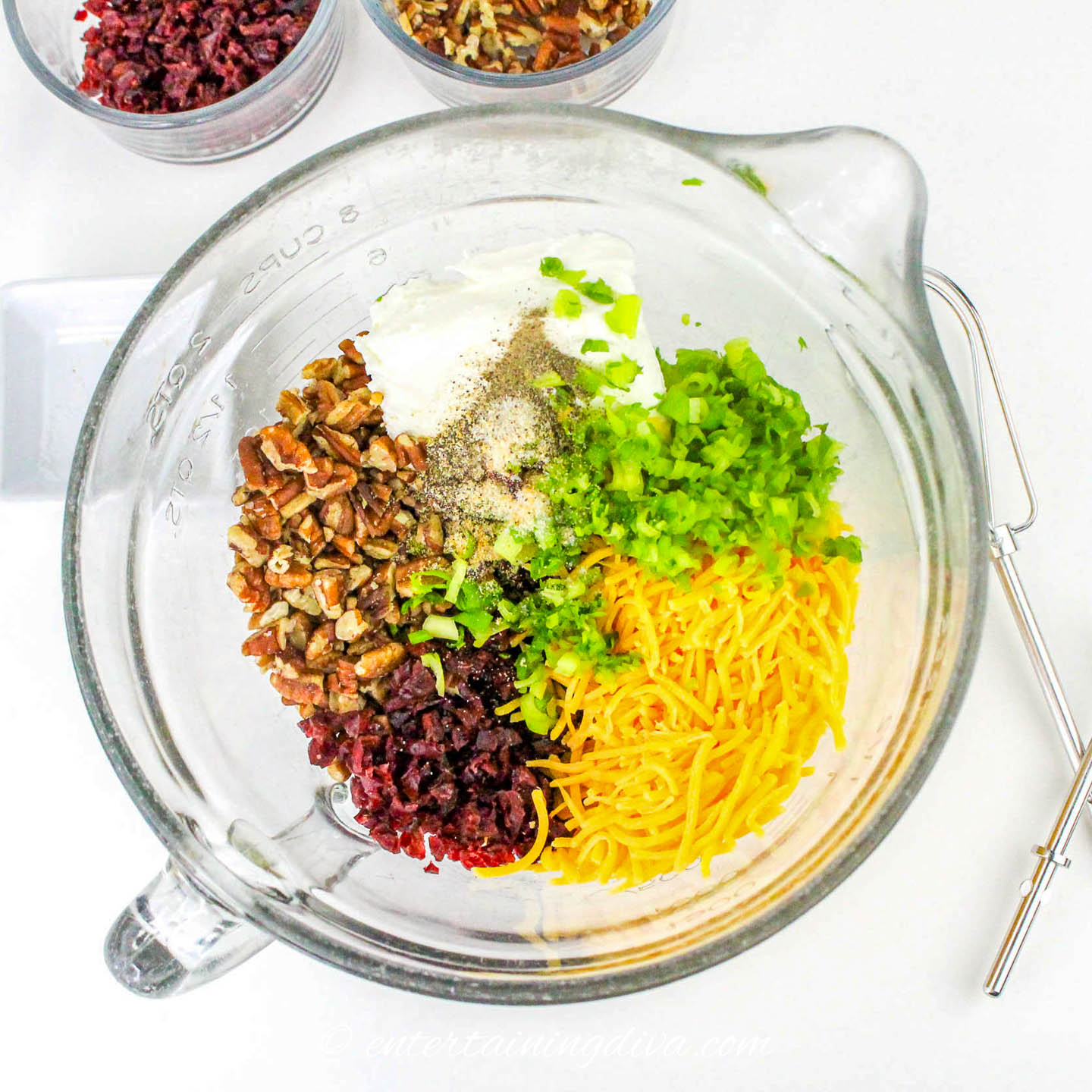 chopped pecans, chopped cranberries, chopped parsley and grated cheese in a mixing bowl