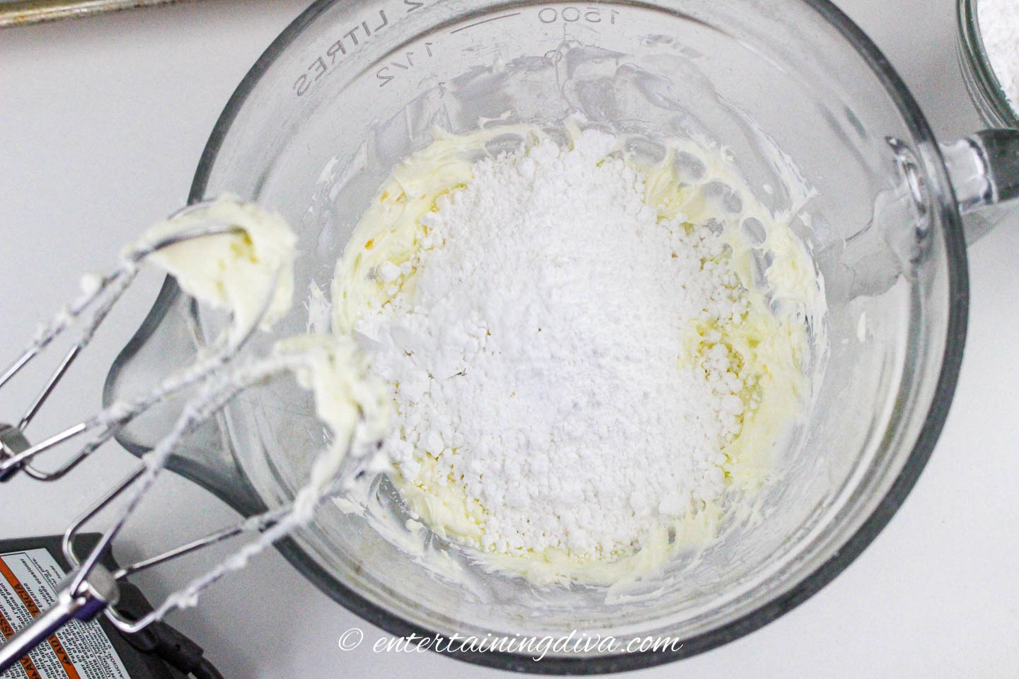 Icing sugar in a bowl with cream cheese and butter