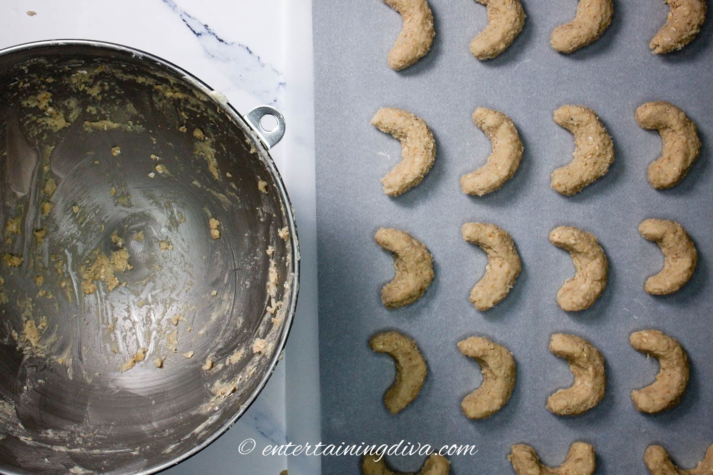 crescent cookies on a baking sheet