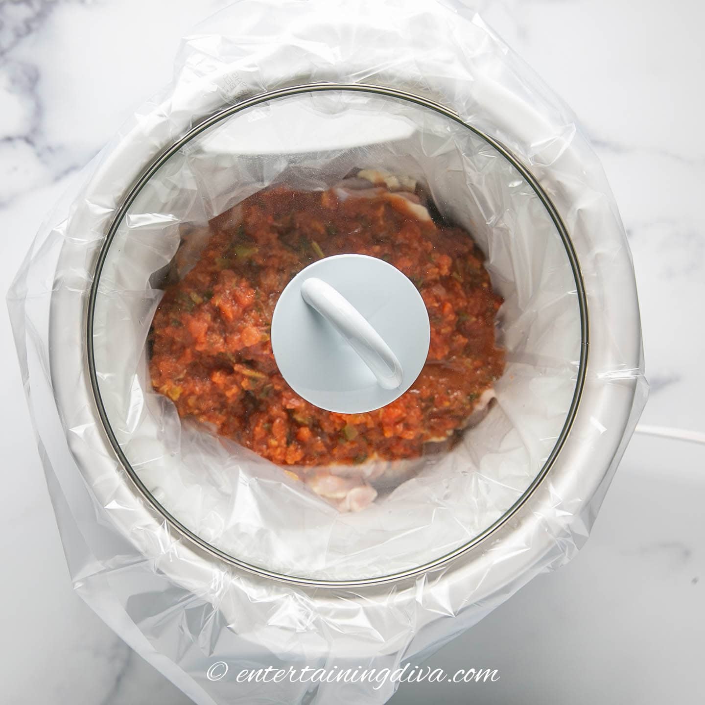 slower cooker with salsa chicken in it