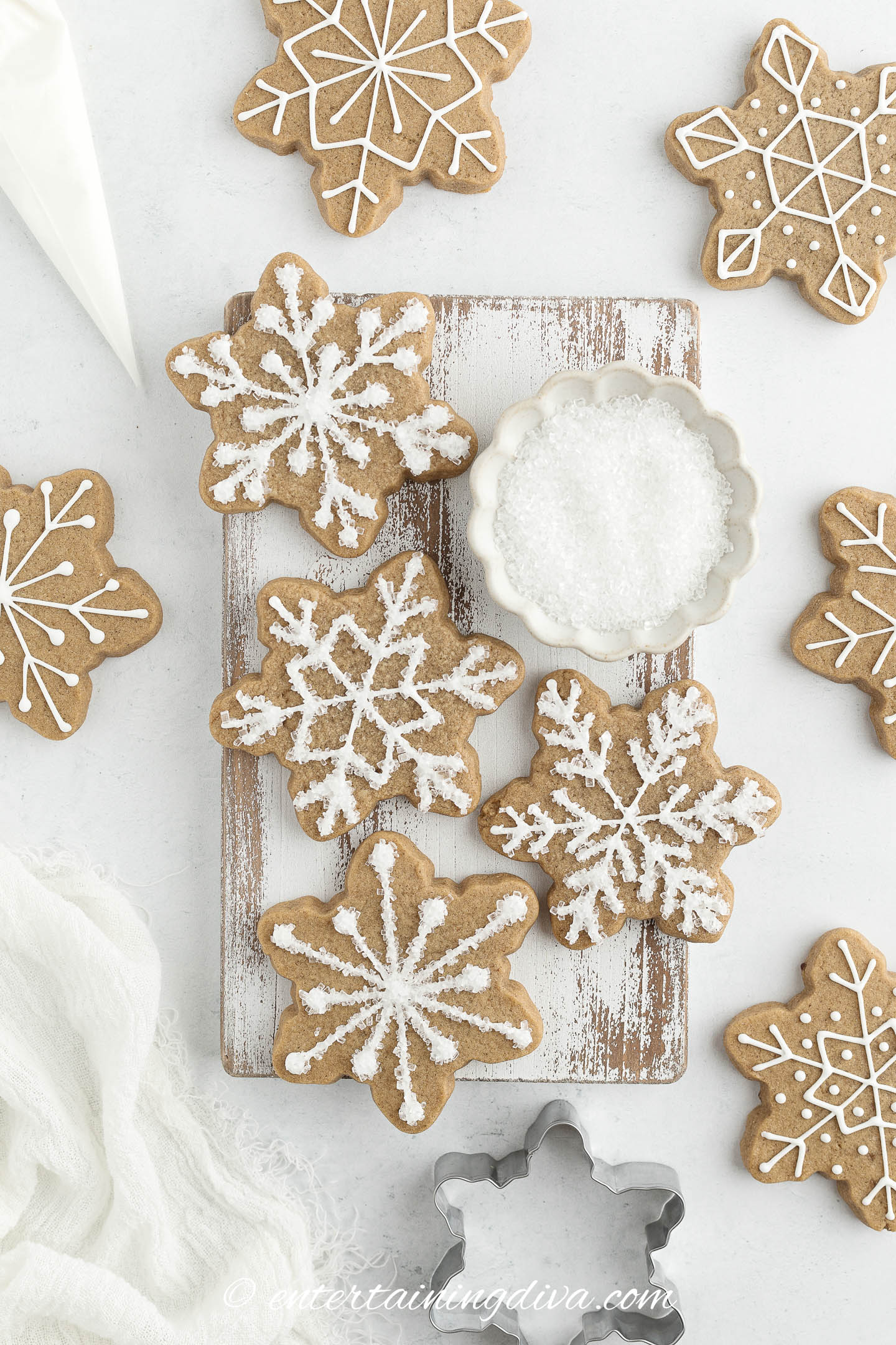 snowflake gingerbread cookies decorated with royal icing and sanding sugar