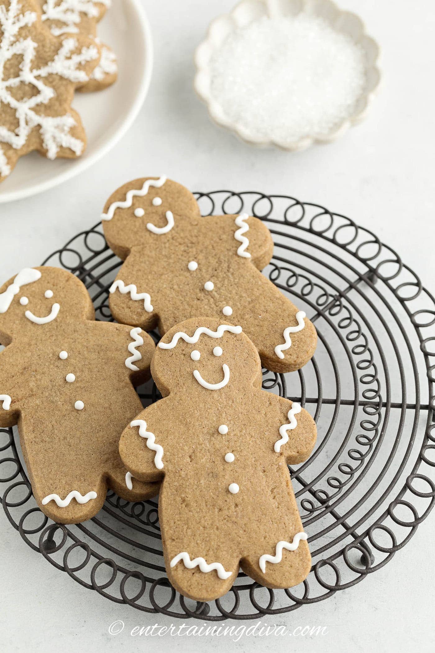 Three gingerbread men cookies on a plate