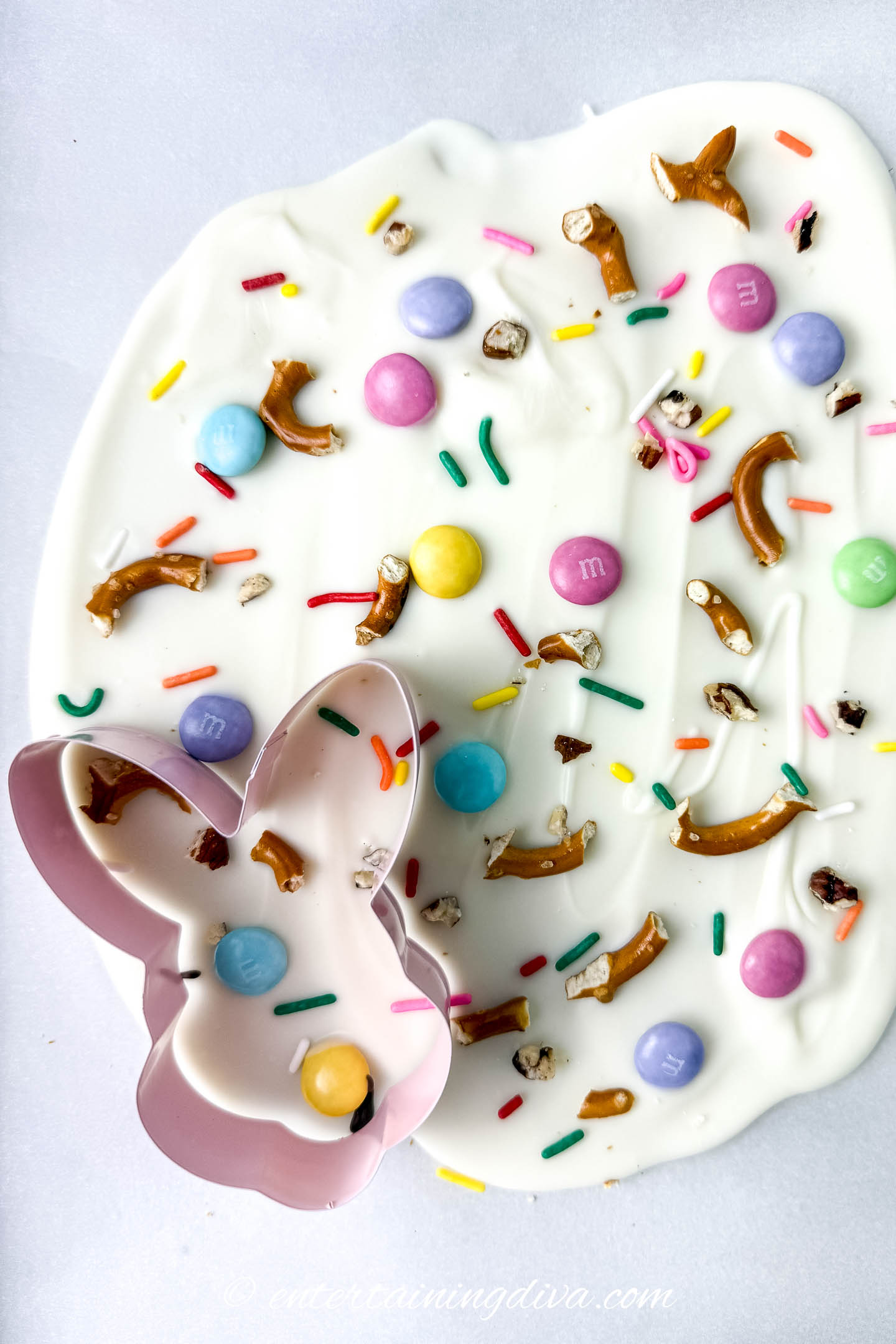 A bunny cookie cutter on white chocolate Easter bark