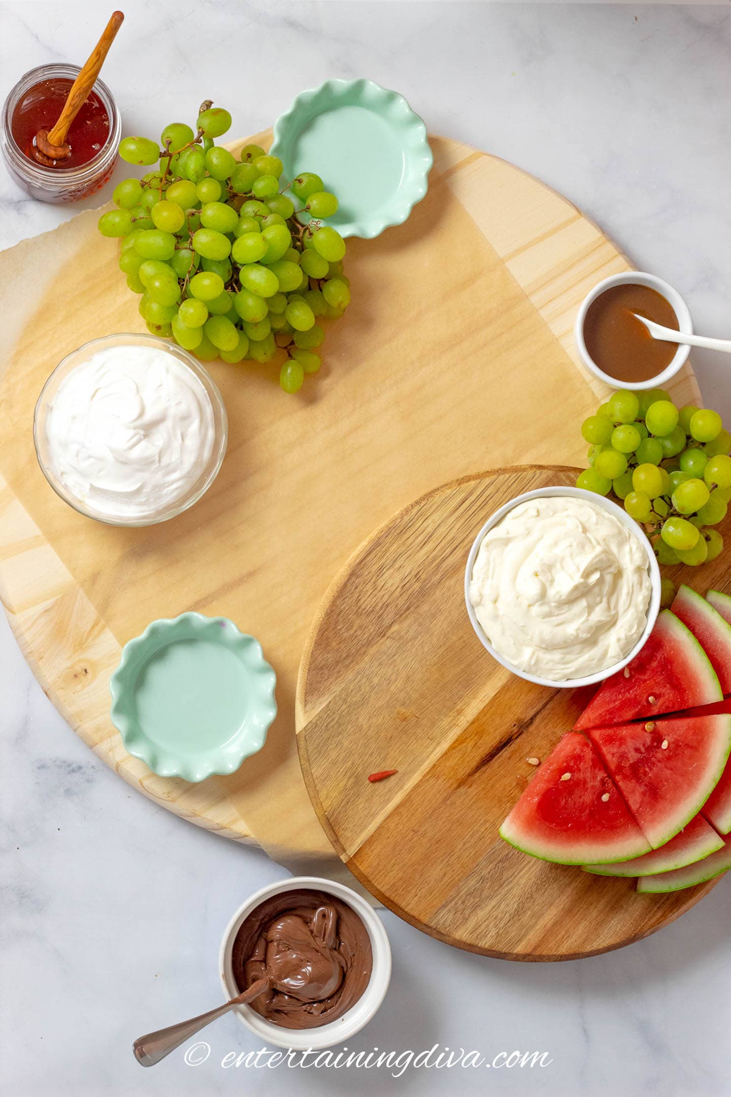 charcuterie board with watermelon, grapes and dips