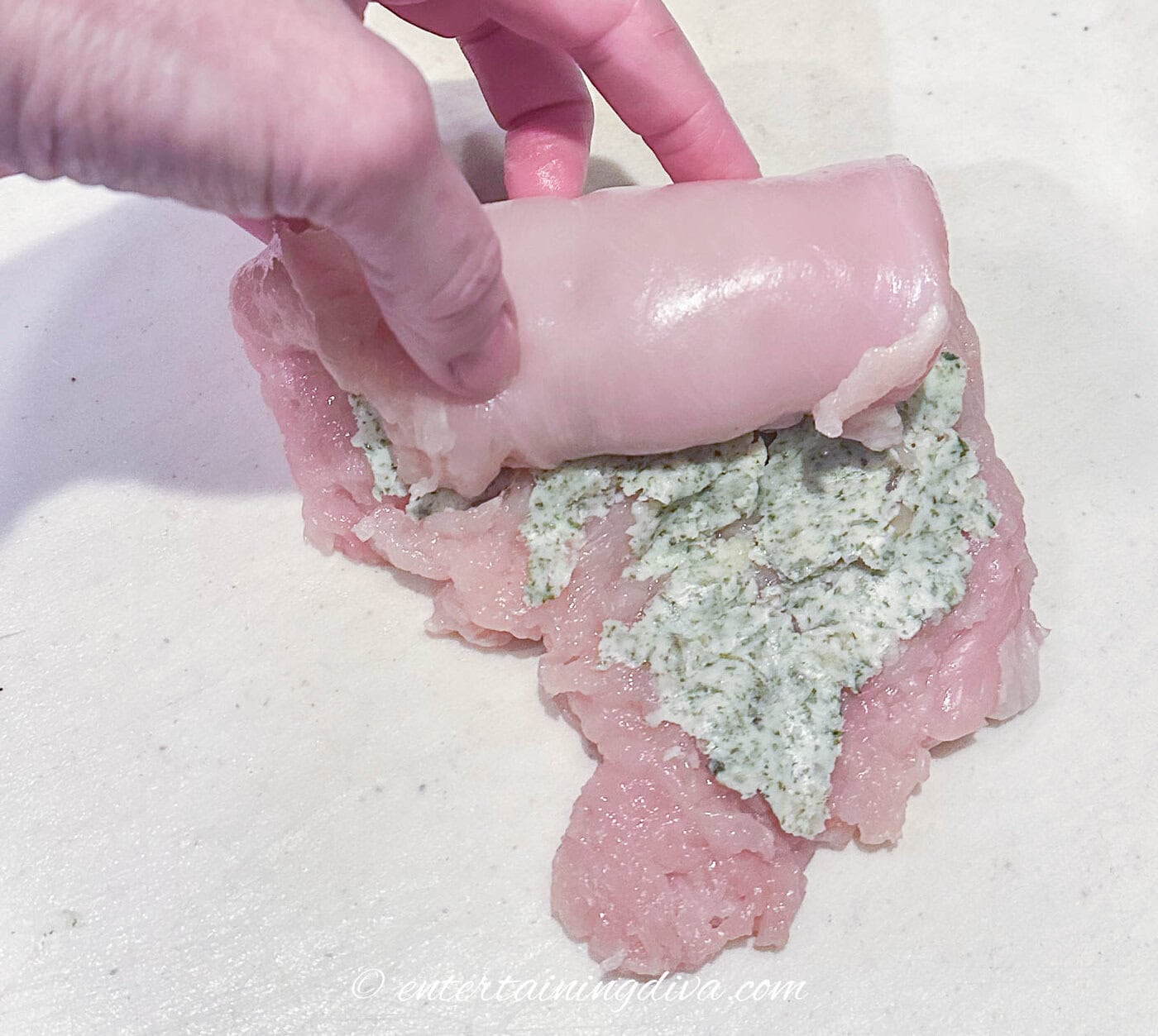 chicken breast being rolled up