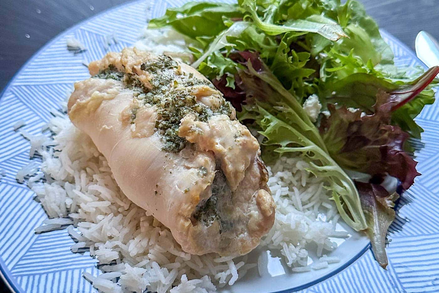 baked garlic butter chicken roll up on a plate