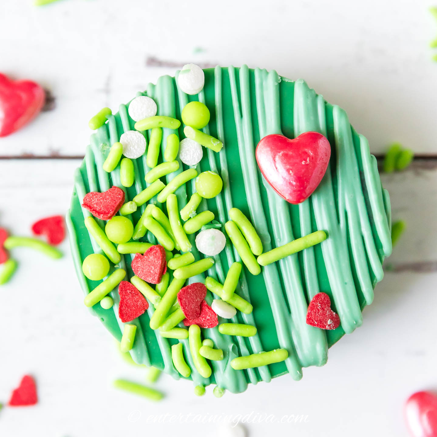 A close up view of the decorations on a Grinch cake puck