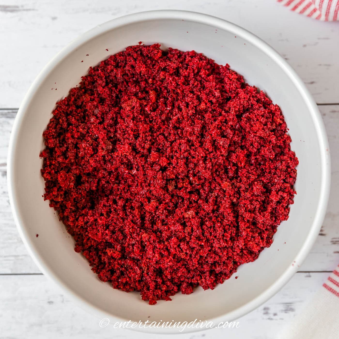 red velvet cake in a bowl after it has been mixed with cream cheese icing