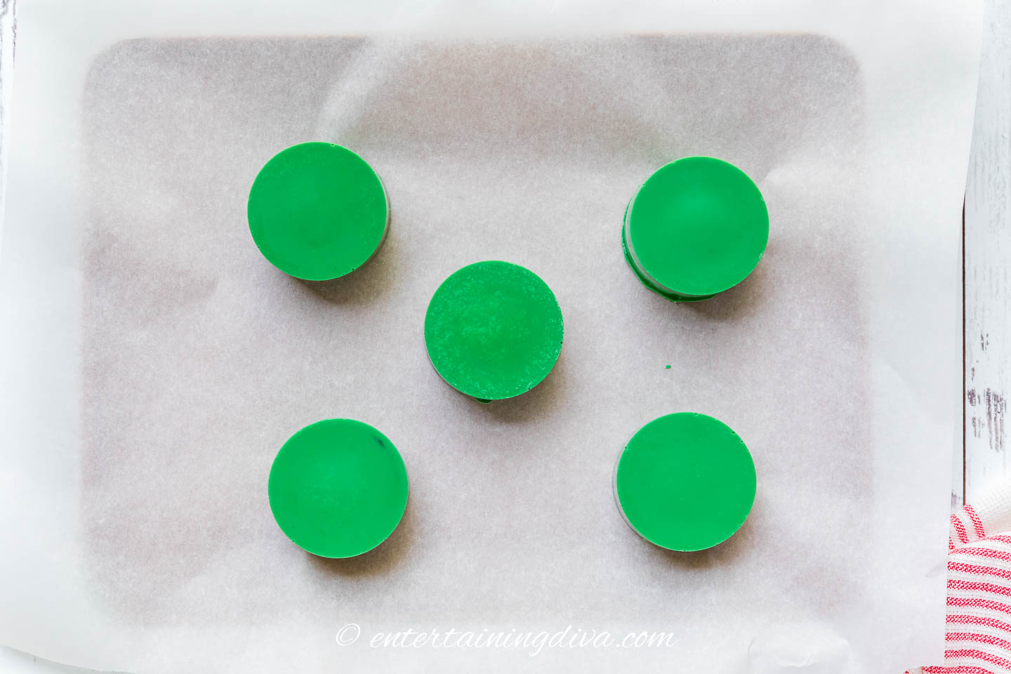 green chocolate covered cake pucks on a piece of parchment paper