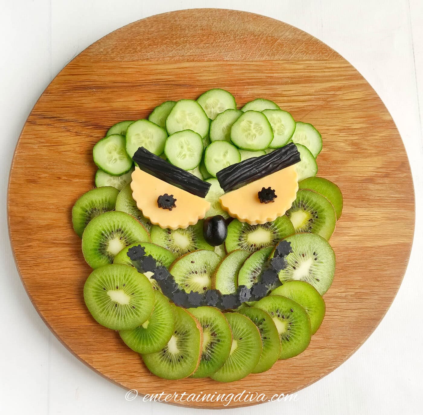 grinch face charctuerie board with licorice eyebrows and mouth