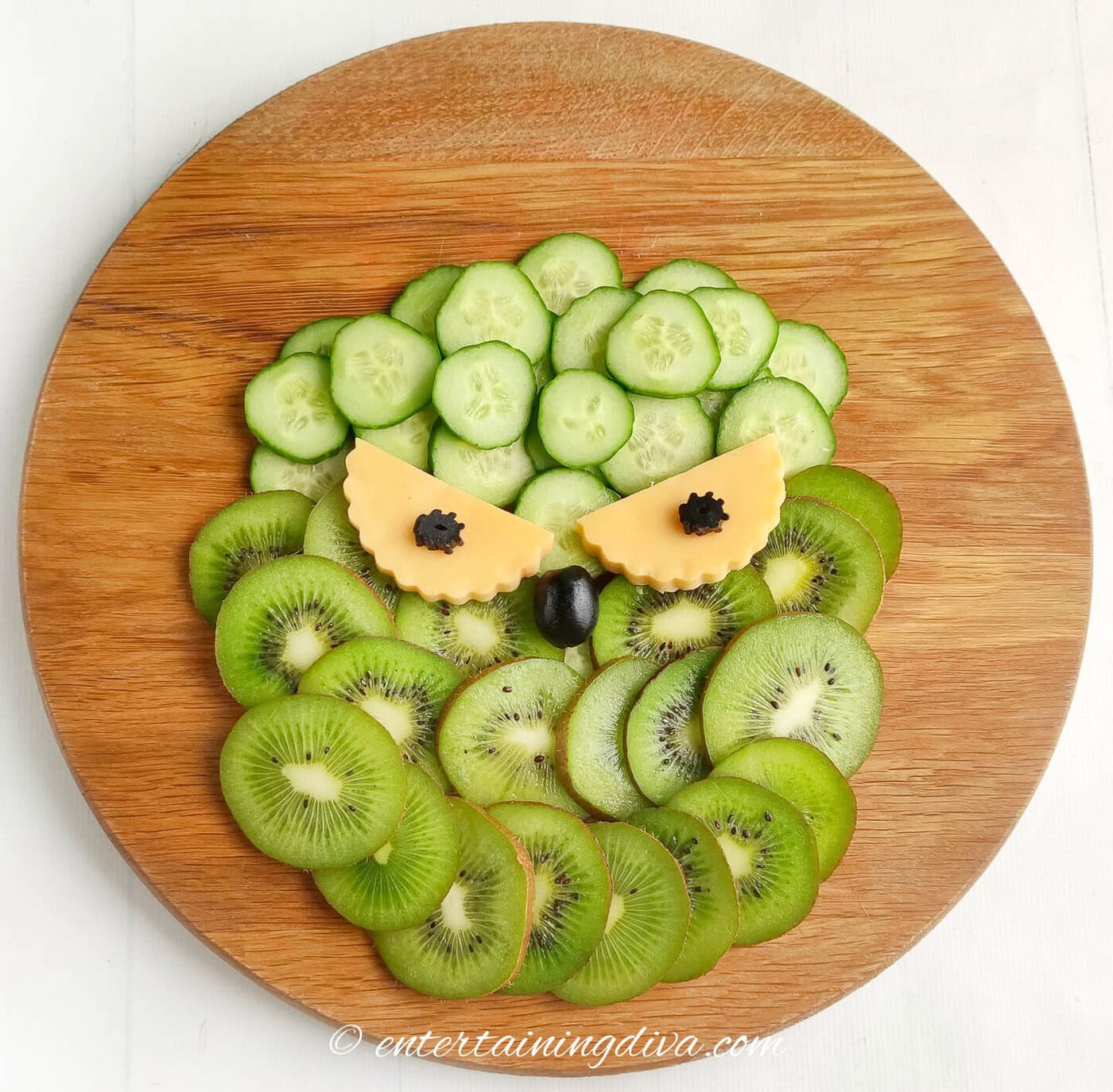 grinch face charctuerie board with eyes and a nose