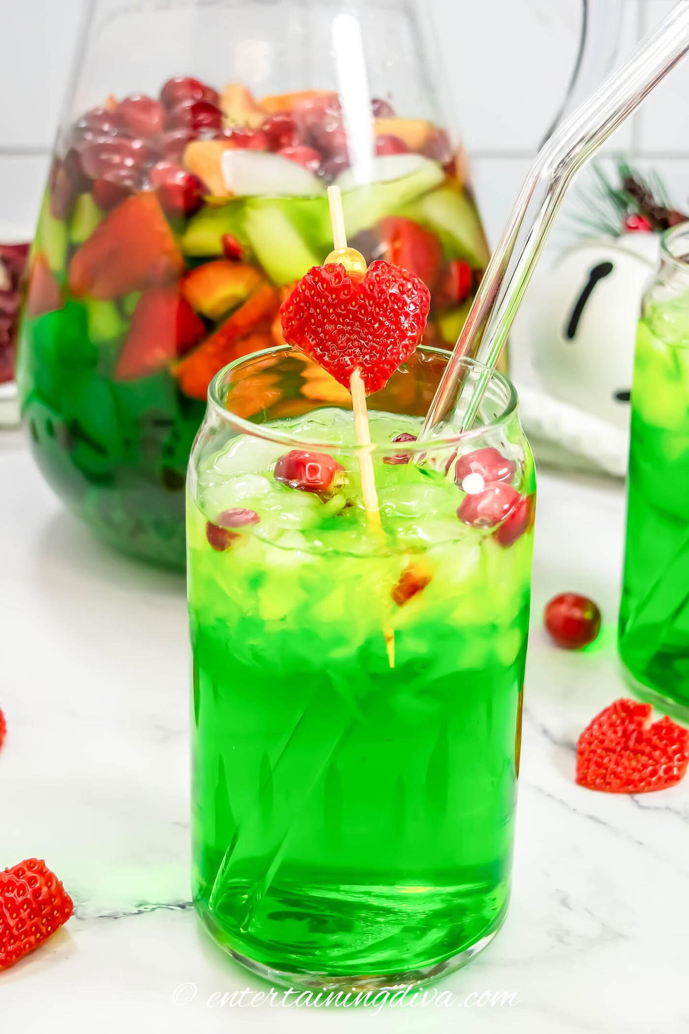 A close up of a glass of green Grinch sangria