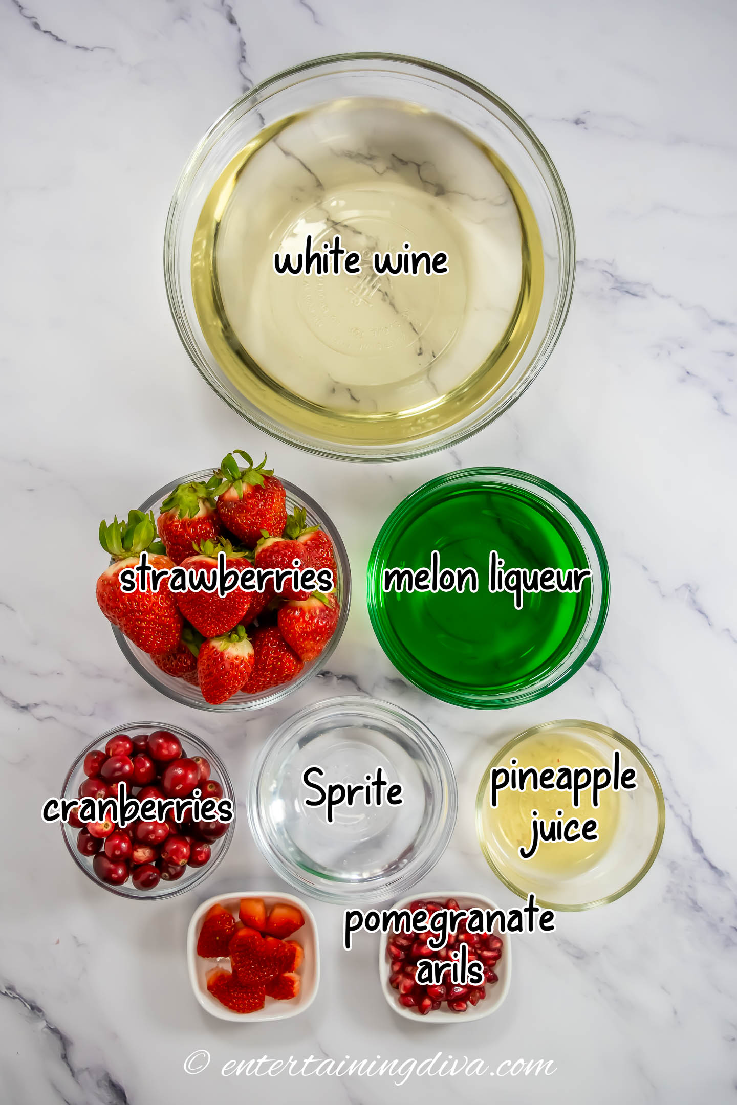 grinch sangria ingredients - white wine, melon liqueur, pineapple juice, sprite and fresh berries