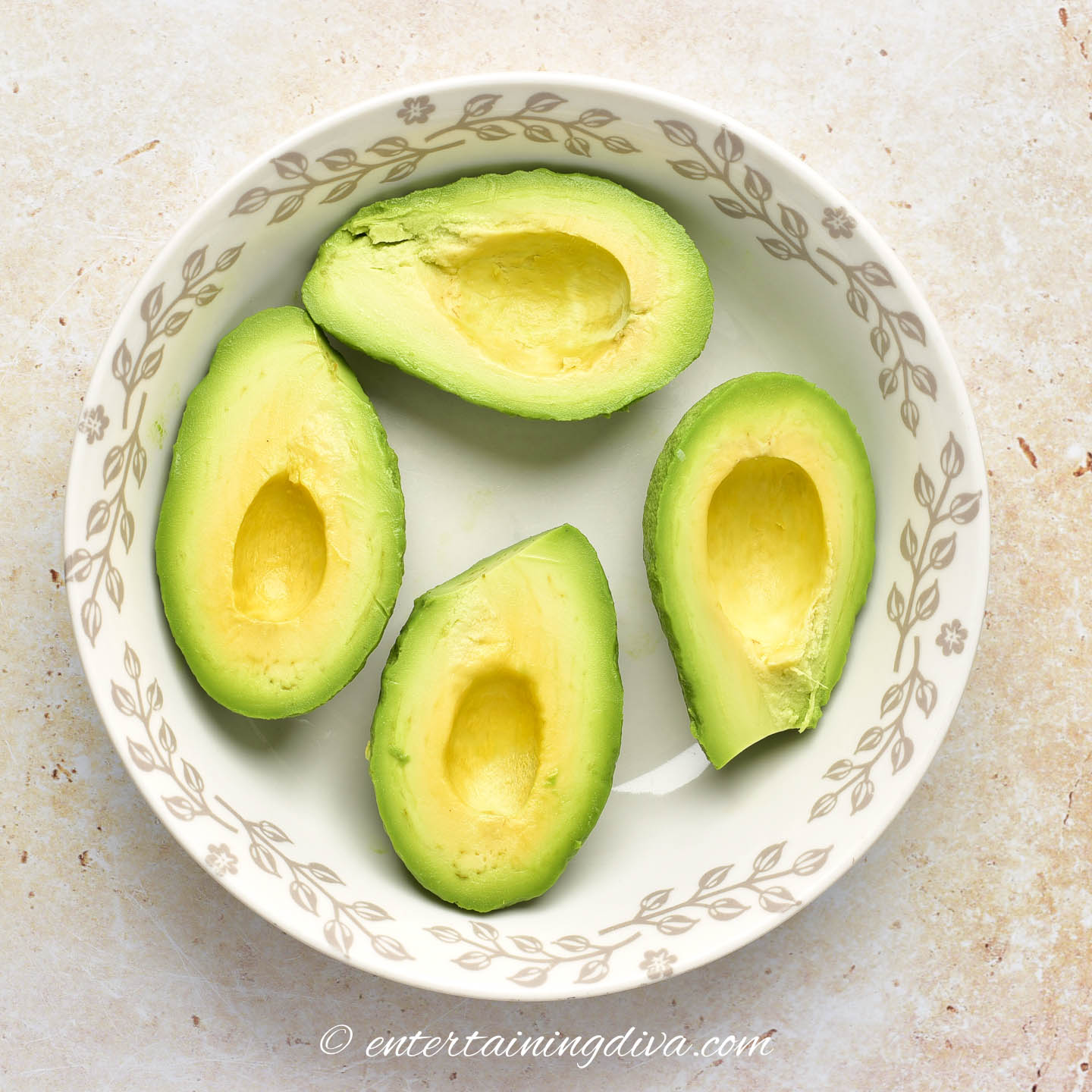 4 avocado halves in a bowl