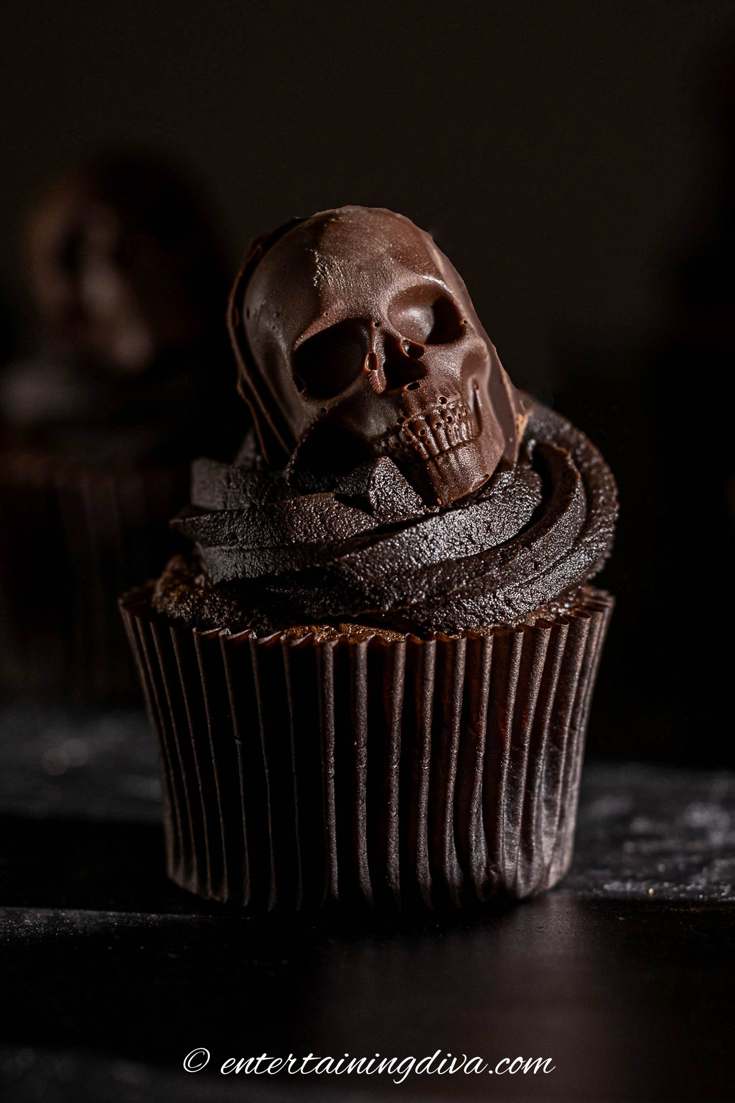 a skull cupcake on a dark background
