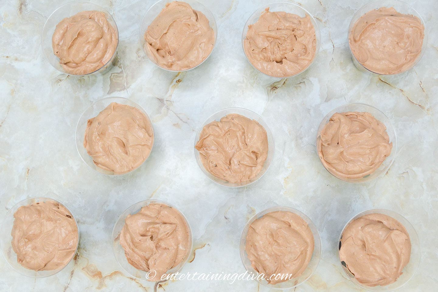 Chocolate pudding on top of chocolate cake in disposable cups