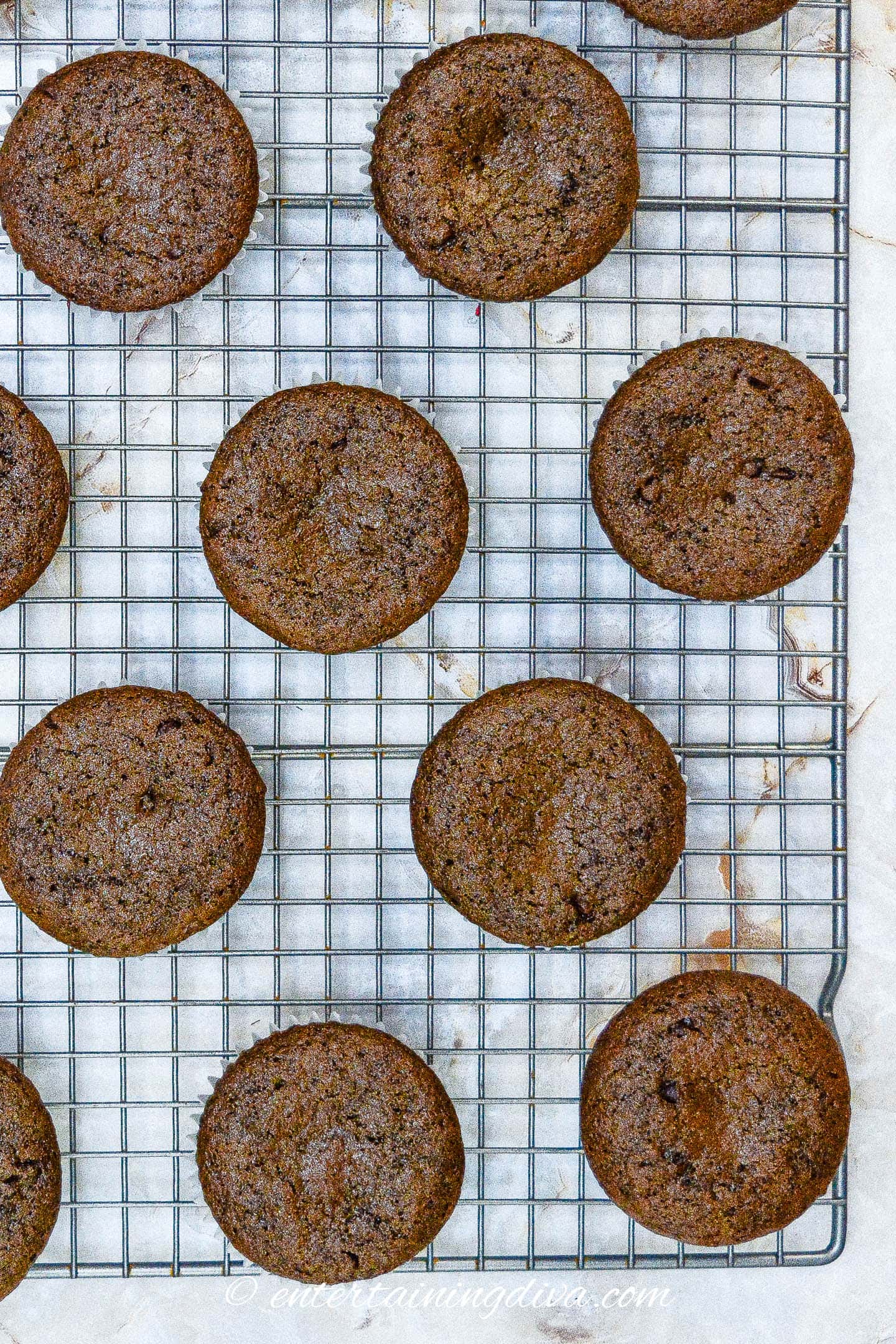 Chocolate cupcakes on a cooling rack.