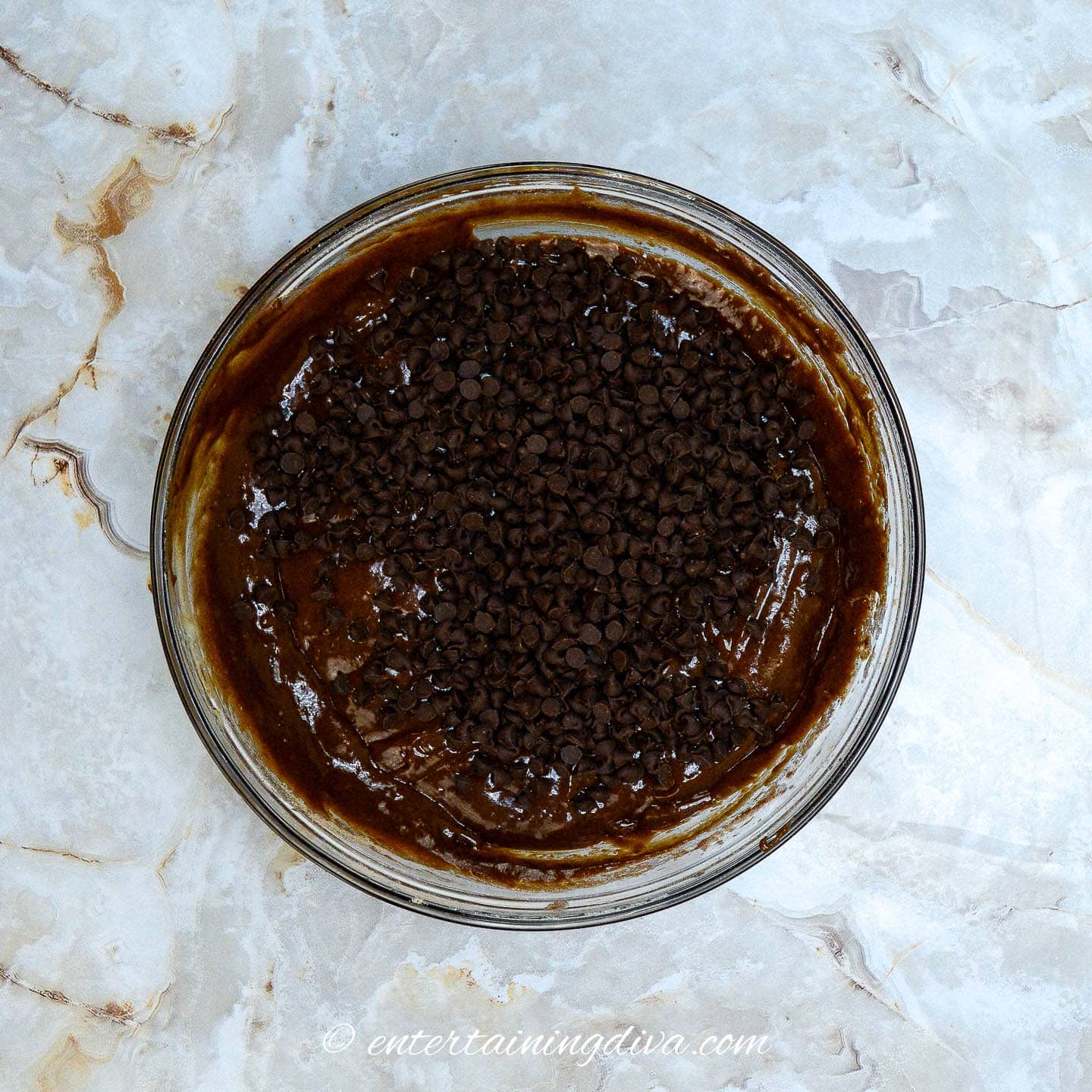 chocolate cupcake batter with chocolate chips in a mixing bowl