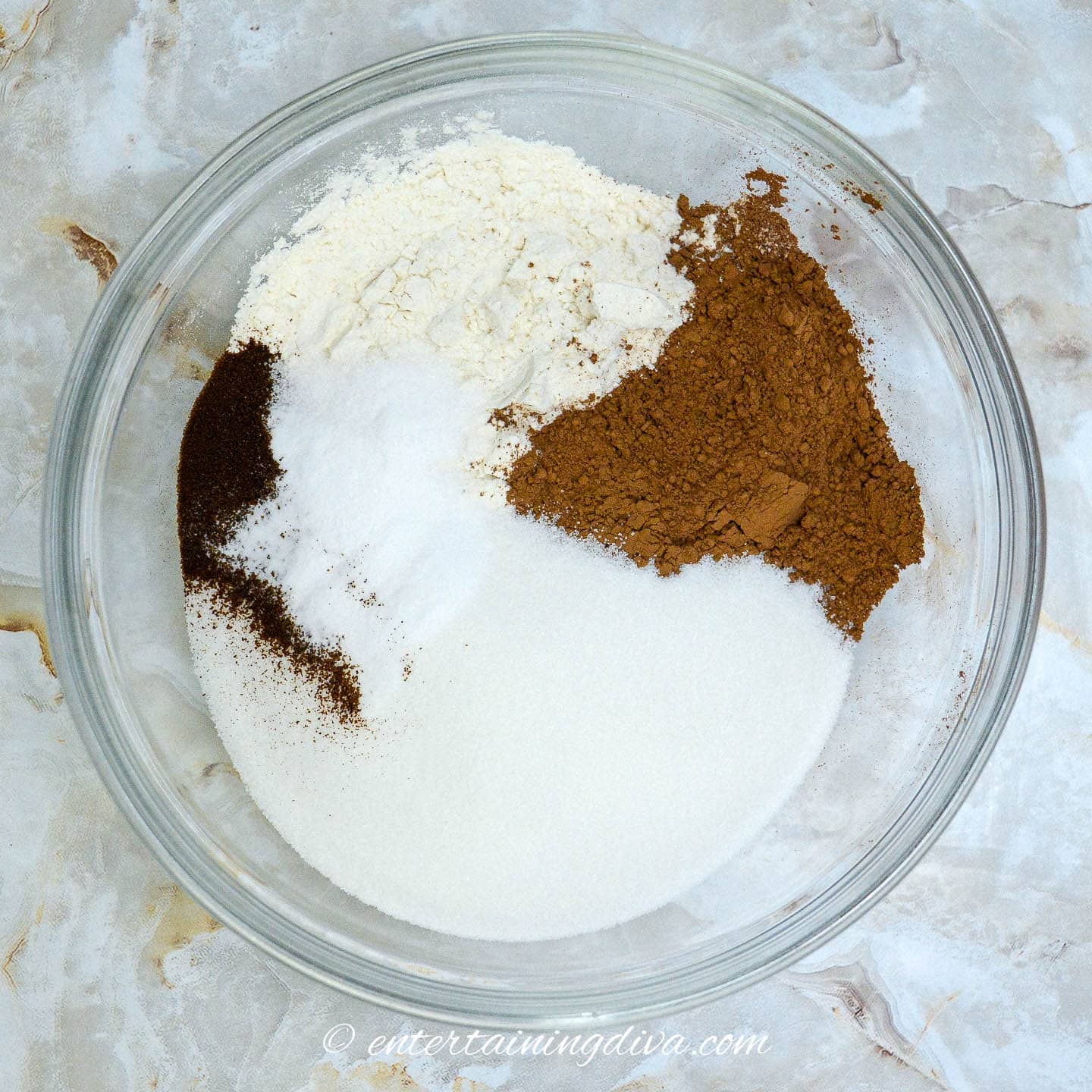 dry ingredients in a bowl on a marble countertop.