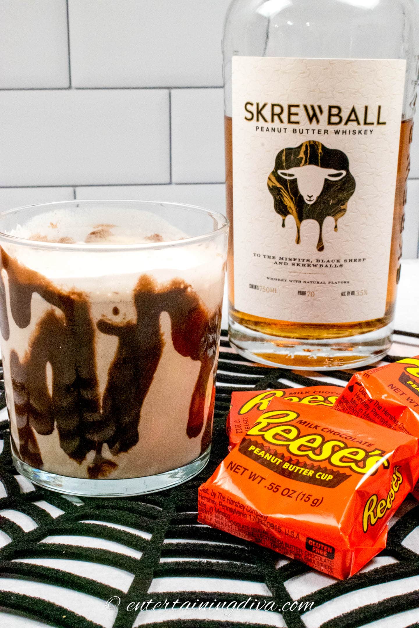 peanut butter cup whiskey cocktail with reese's peanut butter cup in front