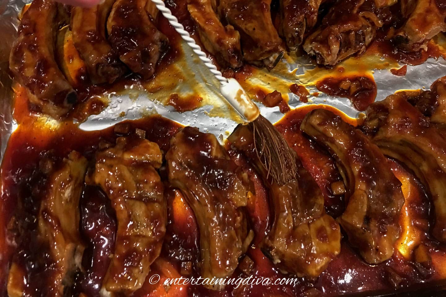 homemade bbq sauce being brushed on wings