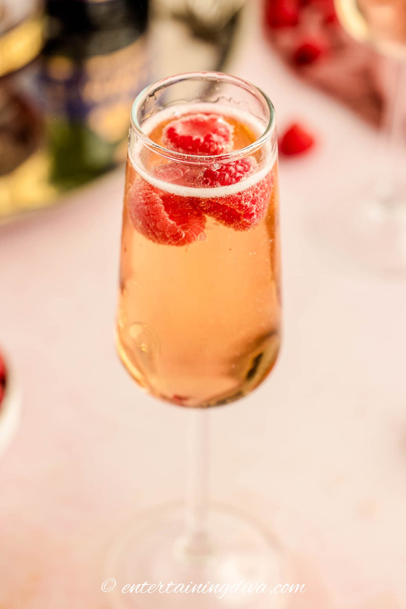 Close up of a kir royale cocktail with raspberries