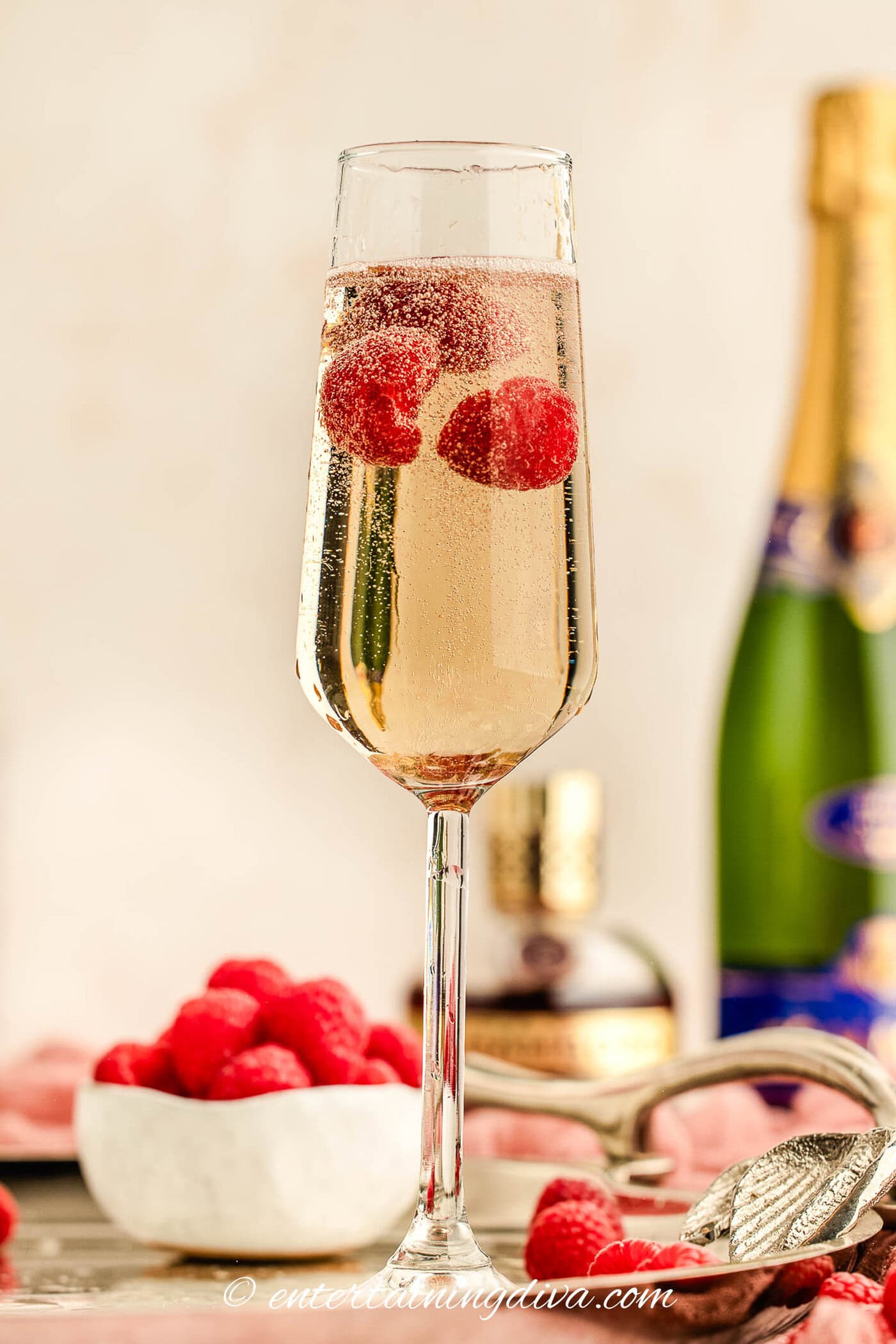 raspberries floating in a glass of Kir Royale