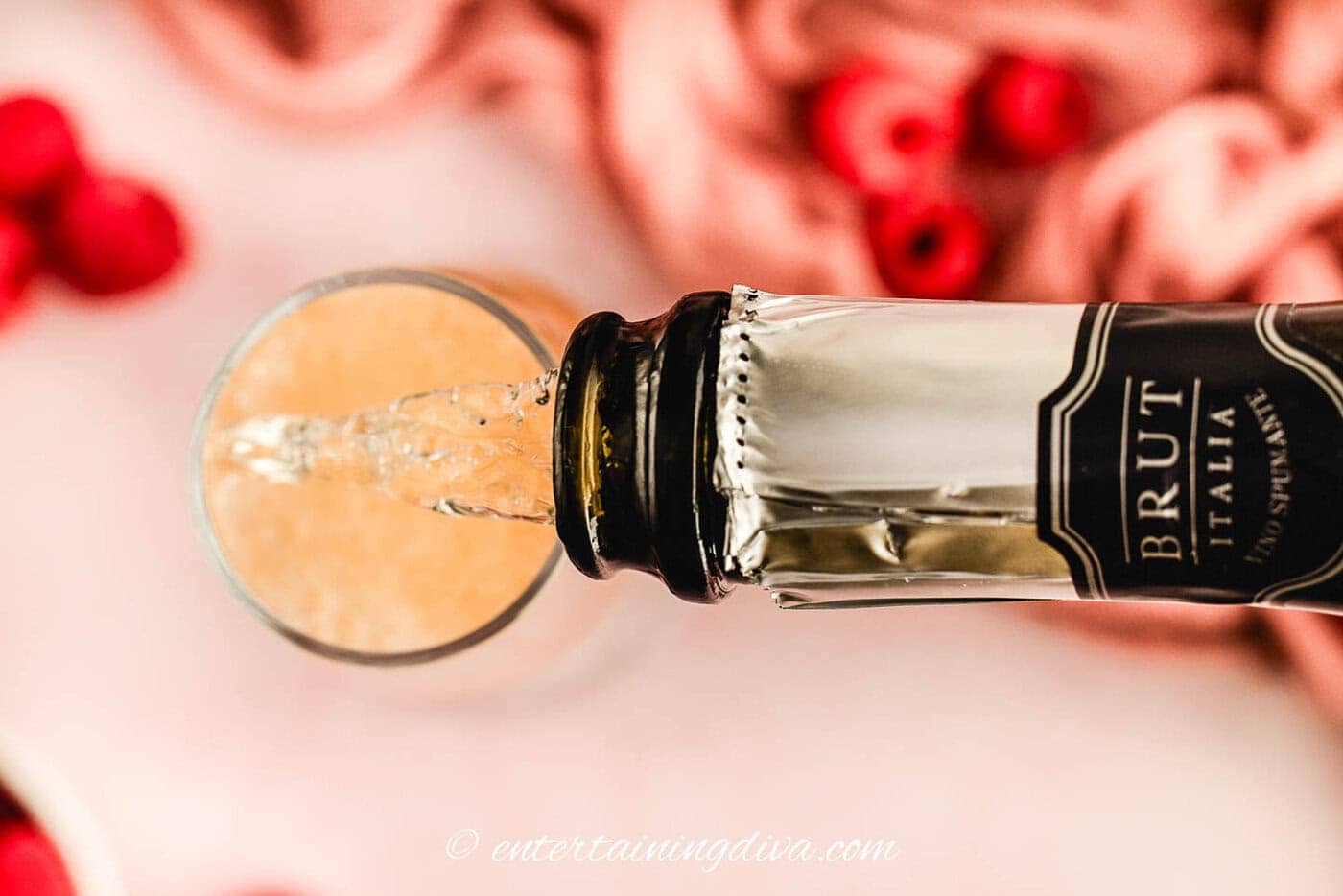 overhead view of champagne being poured into a champagne flute
